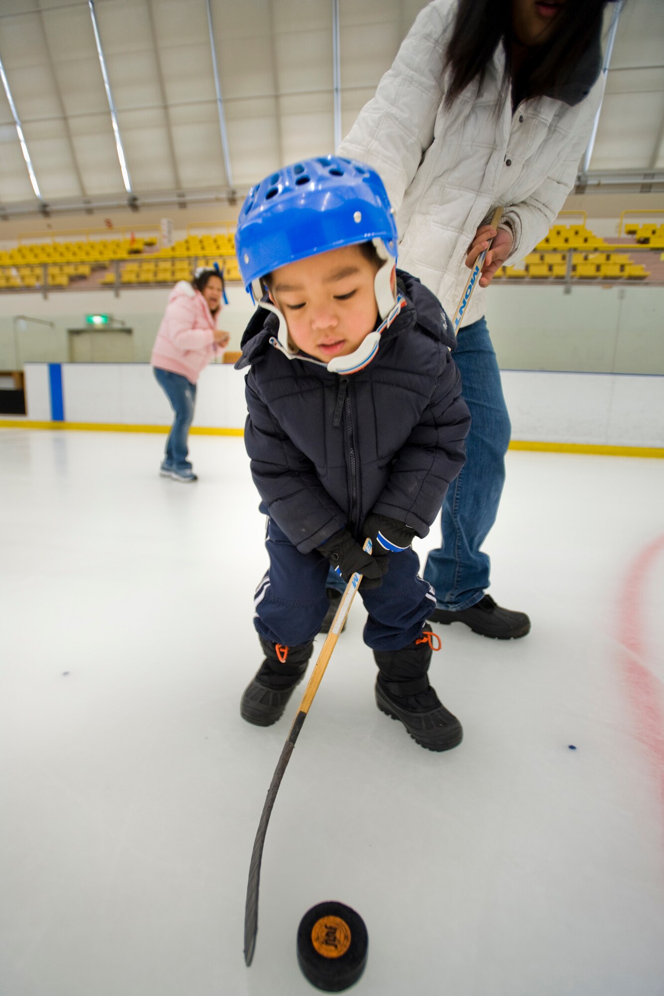 MISAWA CITY, Japan -- Kyle Olympia, son of Navy Chief Petty Officer Howard Olympia, participates in a hockey-puck relay during the 11th annual International Ice Festival March 6 at the Misawa Ice Arena. The festival offered a morning of ice activities for Japanese and American families. (U.S. Air Force photo/Senior Airman Jamal D. Sutter)