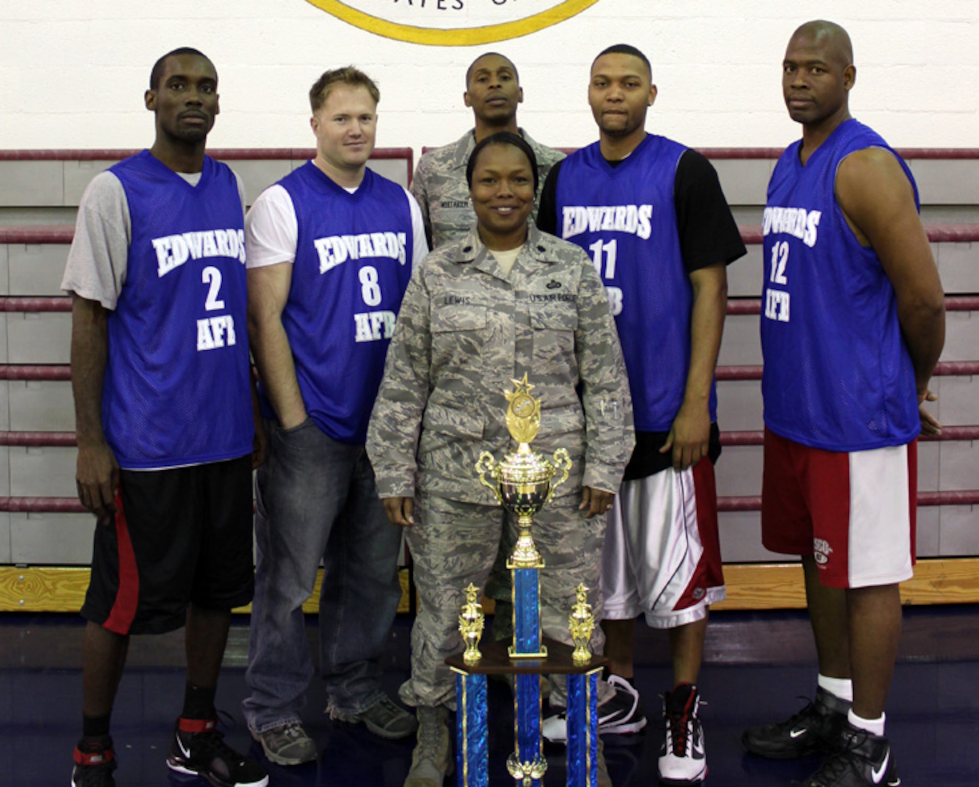 Lt. Col. Susie Lewis, 95th Force Support Squadron commander, and the 95th FSS intramural basketball team stand in front of the 2009-10 Edwards Intramural Basketball Championship trophy. The 95th FSS defeated the 412th Maintenence Squadron Feb. 10 to win the championship. (Courtesy photo)