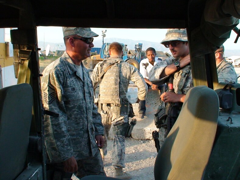 PORT-AU-PRINCE, Haiti -- Master Sgt. Steven Ash, 823rd Expeditionary Security Forces Squadron first sergeant, talks with members from his squadron while here in Haiti Feb. 28. Members of the 823rd ESFS, deployed from Moody Air Force Base, Ga., are responsible for providing security at the Toussaint L'Ouverture International Airport located in Haiti’s capital. (U.S. Air Force photo by Capt. Jonathan McDonald)