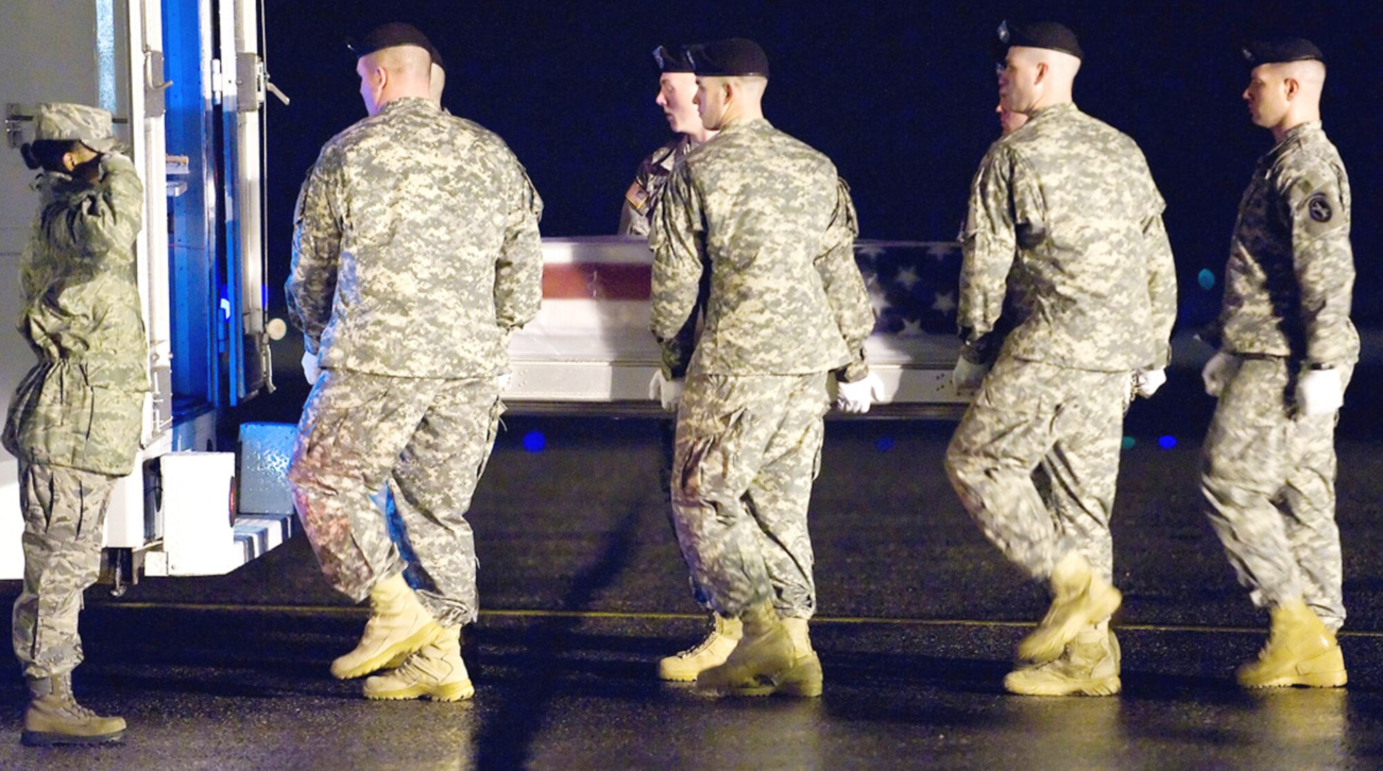 An Army carry team places a transfer case containing a fallen servicemember's remains into a vehicle during a dignified transfer Feb. 22, 2010, at Dover Air Force Base, Del. The vehicle will transport the case to the Air Force Mortuary Affairs Operations Center, where all U.S. servicemembers killed in combat are prepared for burial. (U.S. Air Force photo/Roland Balik)