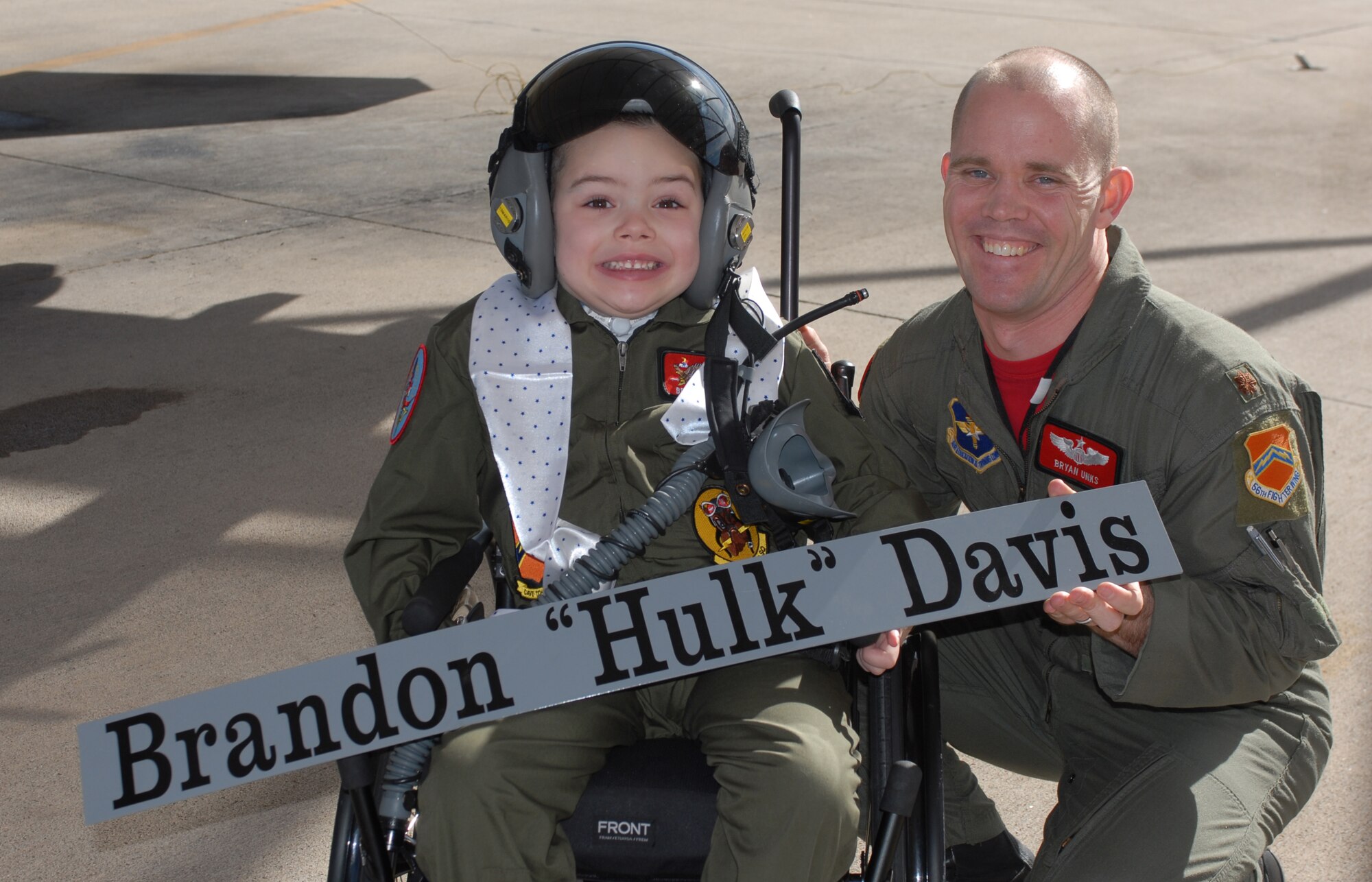 Brandon "Hulk" Davis and Maj. Bryan Unks, 56th Training Squadron, pose for a photo after Brandon saw his name on an F-16 during pilot-for-a-day Feb. 26. (Photo by Airman 1st Class Sandra Welch)