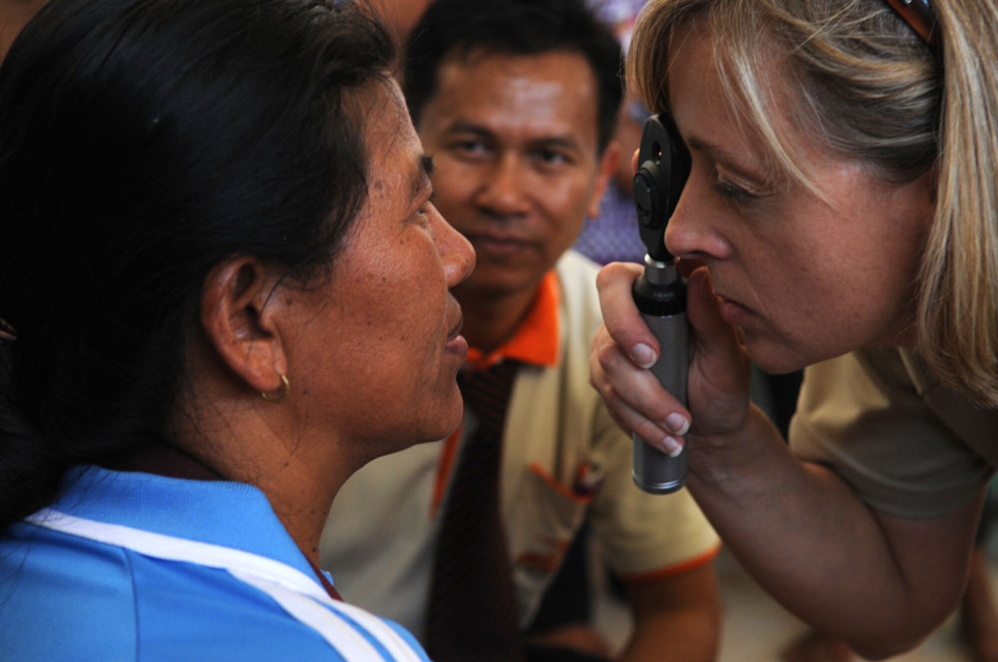 Maj. (Dr.) Patti Fries examines the eyes of a local Thai man at Ban Nong Sroung School in Thailand during a Cope Tiger 2010 community relations event March 4.  Major Fries is a guardsman deployed to the exercise from the 131st Medical Group at Whiteman Air Force Base, Mo.  Airmen from the U.S., Royal Thai and Republic of Singapore air forces are providing medical, dental and optometry care to local residents as part of the multilateral exercise. (U.S. Air Force photo/Tech Sgt. Cohen A. Young)
