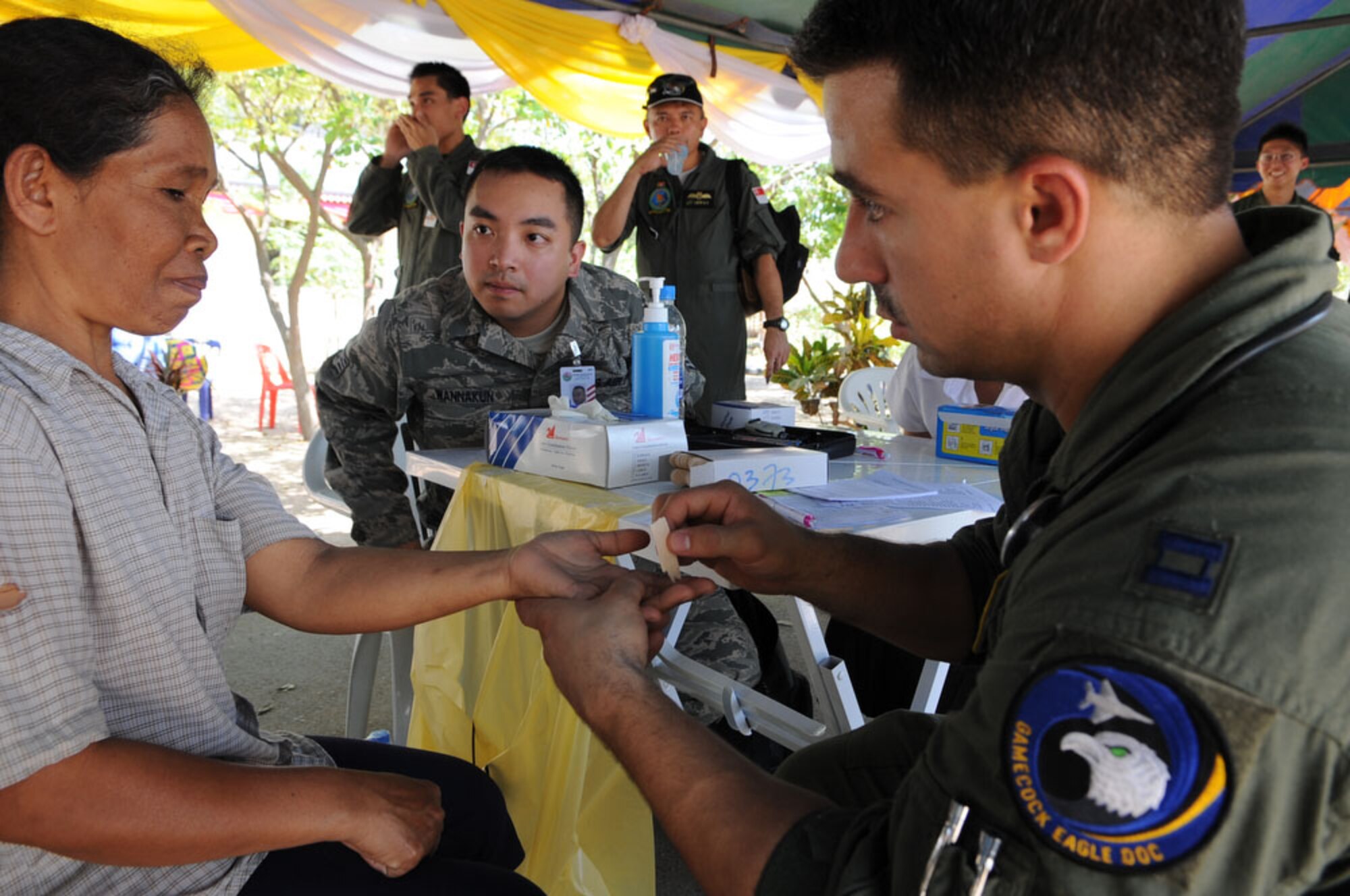Captain (Dr.) Mike DiBartolo, a flight medicine doctor from the 19th Fighter Squadron at Elmendorf Air Force Base, Alaska, evaluates a local Thai woman's sense of touch during a medical exam conducted in Ban Nong Sroung, Thailand as part of exercise Cope Tiger 2010 March 4.  Cope Tiger 2010 is an annual multilateral aerial large force exercise conducted in Thailand that includes humanitarian and civic assistance programs. This year's exercise takes place primarily at Udon Thani and Korat Royal Thai Air Force Bases March 1-12. (U.S.  Air Force photo/Tech Sgt. Cohen A. Young)