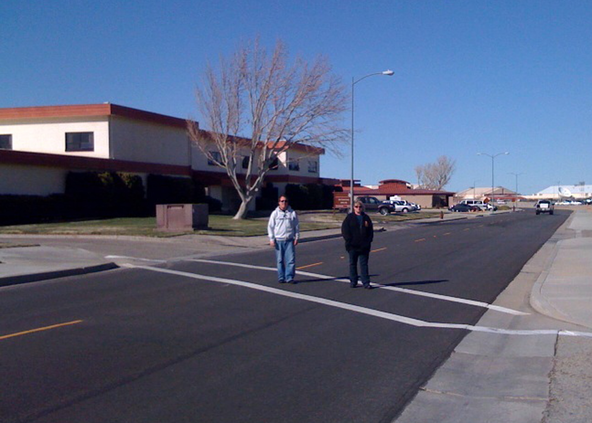 Base personnel safely cross the street in a crosswalk after looking both ways March 4. (Courtesy photo)