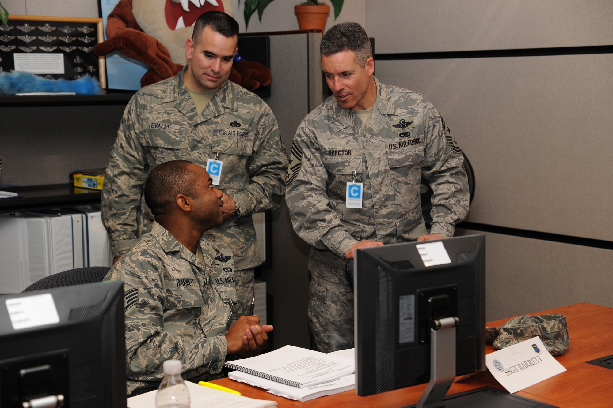 Chief Master Sgt. David Spector, Air Mobility Command command chief, and Chief Master Sgt. John Evalle, 436th Air Wing Command Chief, speak with a student in the Aviation Resource Management System Report Writer course March 3 during a tour of the U.S. Air Force Expeditionary Center.  Chief Spector hosted a 12 Outstanding Airman of the Year conference at the Expeditionary Center to assist other AMC command chiefs experience what the Center has to offer.  (U.S. Air Force Photo/Staff Sgt. Nathan G. Bevier)