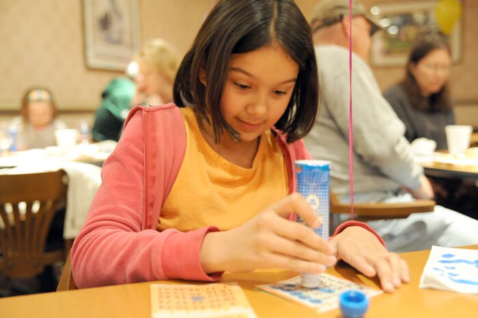 Brianna McCormick marks a number on her bingo card during Family Night at the Charleston Club March 4, 2010, at Joint Base Charleston, S.C. Families enjoyed pizza, spaghetti, ice cream and bingo at this month's event. The next scheduled Family Night is set for April 1, 2010. Brianna is the daughter of Tech. Sgt. Kevin McCormick who is with the 628th Civil Engineer Squadron. (U.S. Air Force photo/Staff Sgt. Marie Brown)