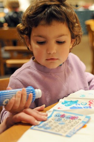 Olivia Witmore waits for her number to be called so she can mark her bingo card during Family Night at the Charleston Club March 4, 2010, at Joint Base Charleston, S.C. The Charleston Club hosts Family Night the first Thursday of every month. The next scheduled Family Night is set for April 1, 2010. Olivia is the daughter of Jake and Heather Witmore who were guests of a JB CHS member for the evening. (U.S. Air Force photo/Staff Sgt. Marie Brown)