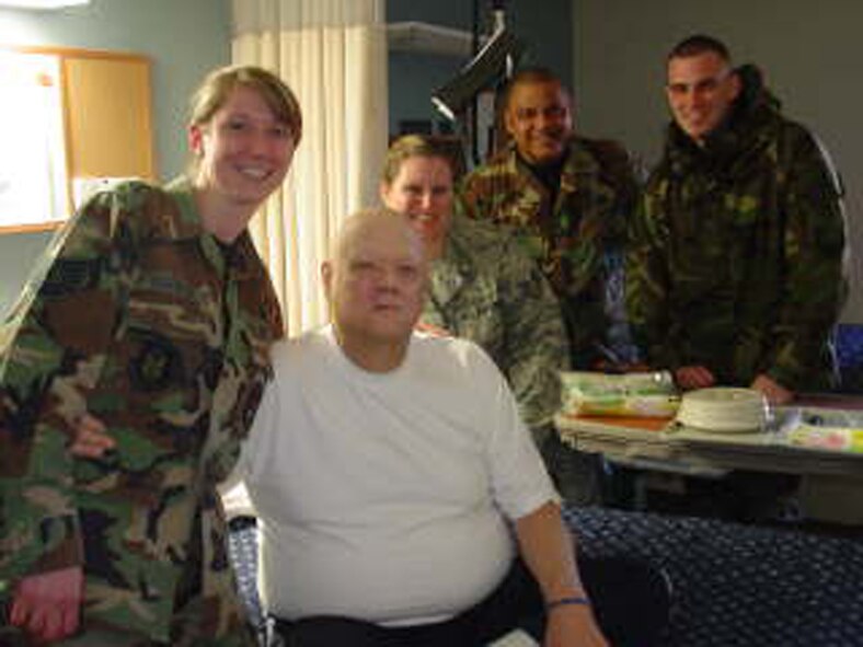 WRIGHT-PATTERSON AIR FORCE BASE, Ohio – Chief Master Sgt. J. J. Smith (second from the right), 445th Maintenance Squadron, and fellow reservists from the wing visit with Mr. Paul McDonald (shown here) and other residents at the Veterans Affairs Medical Center, Dayton, Ohio, during the Mar. 6. unit training assembly. (U.S. Air Force photo/Unit Public Affairs Representative Maj. Mary Reed) 