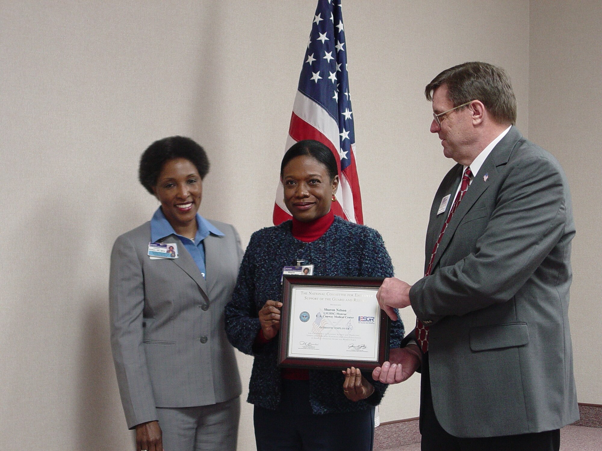 Sharon Nelson, a supervisor at the Louisiana State University Health Service Center in Monroe, La., receives the Patriot Award from Dennis Dollar, a representative of Employer Support of the Guard and Reserve. On the left is Lt. Col. Corine M. Barral-Sutton, a surgical nurse for the 917th Medical Squadron. The ESGR gains and maintains employer support for Guard and Reserve servicemembers by recognizing outstanding support, increasing awareness of the law and resolving conflicts through mediation.
 (Courtesy Photo)
