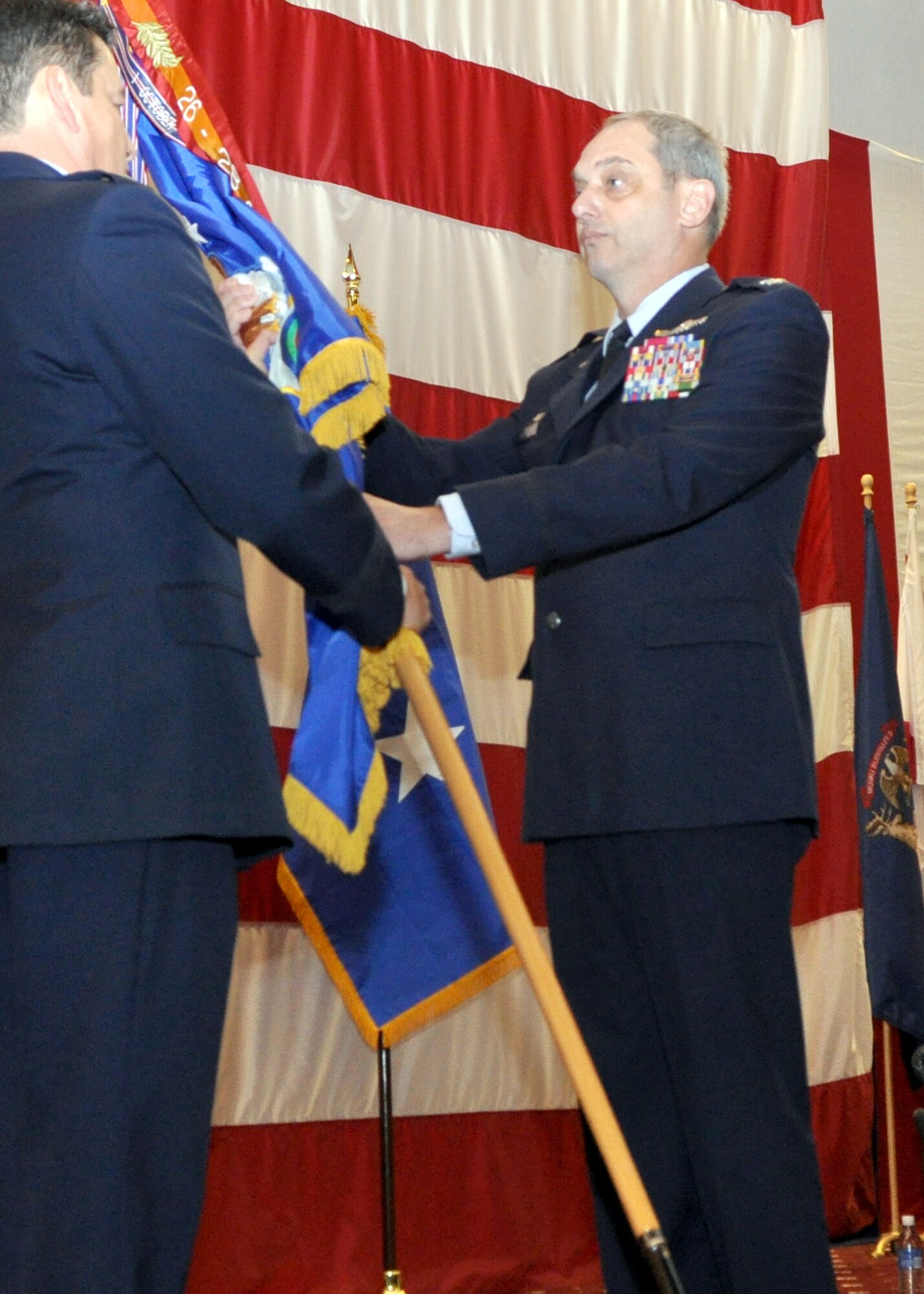 Col. John J. Mooney III accepts the 917th Wing’s flag and command of the Barksdale Air Force Base unit during a change of command ceremony on Barksdale March 6, 2010 from Maj. Gen. Frank Padilla, commander of the 10th Air Force, Fort Worth, Texas. Col. Mooney, once the 917th Operations Group commander, returns to Barksdale Air Force Base and the unit from the 10th AF, where he served as an assistant vice commander and chief of staff. (U.S. Air Force Photo/Senior Airman Crystal Marie Jordan)