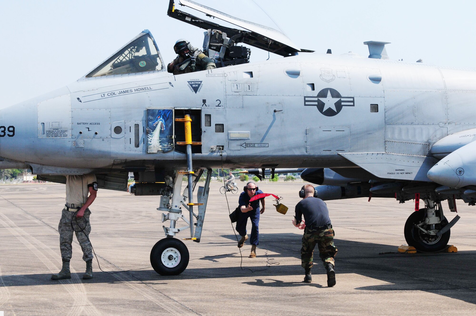 Airmen discard the "remove before flight" streamers prior to an A-10 Thunderbolt II take-off March 4, 2010, at Udon Thani Royal Thai Air Force Base, Thailand. The Airmen are participating in the annual, multilateral field training exercise involving the U.S. Air Force, Royal Thai Air Force and army, and the Republic of Singapore Air Force March 1-12. The Airmen are from the 25th Aircraft Maintenance Unit at Osan Air Base, South Korea. (U.S. Air Force photo/Capt. Genieve David)