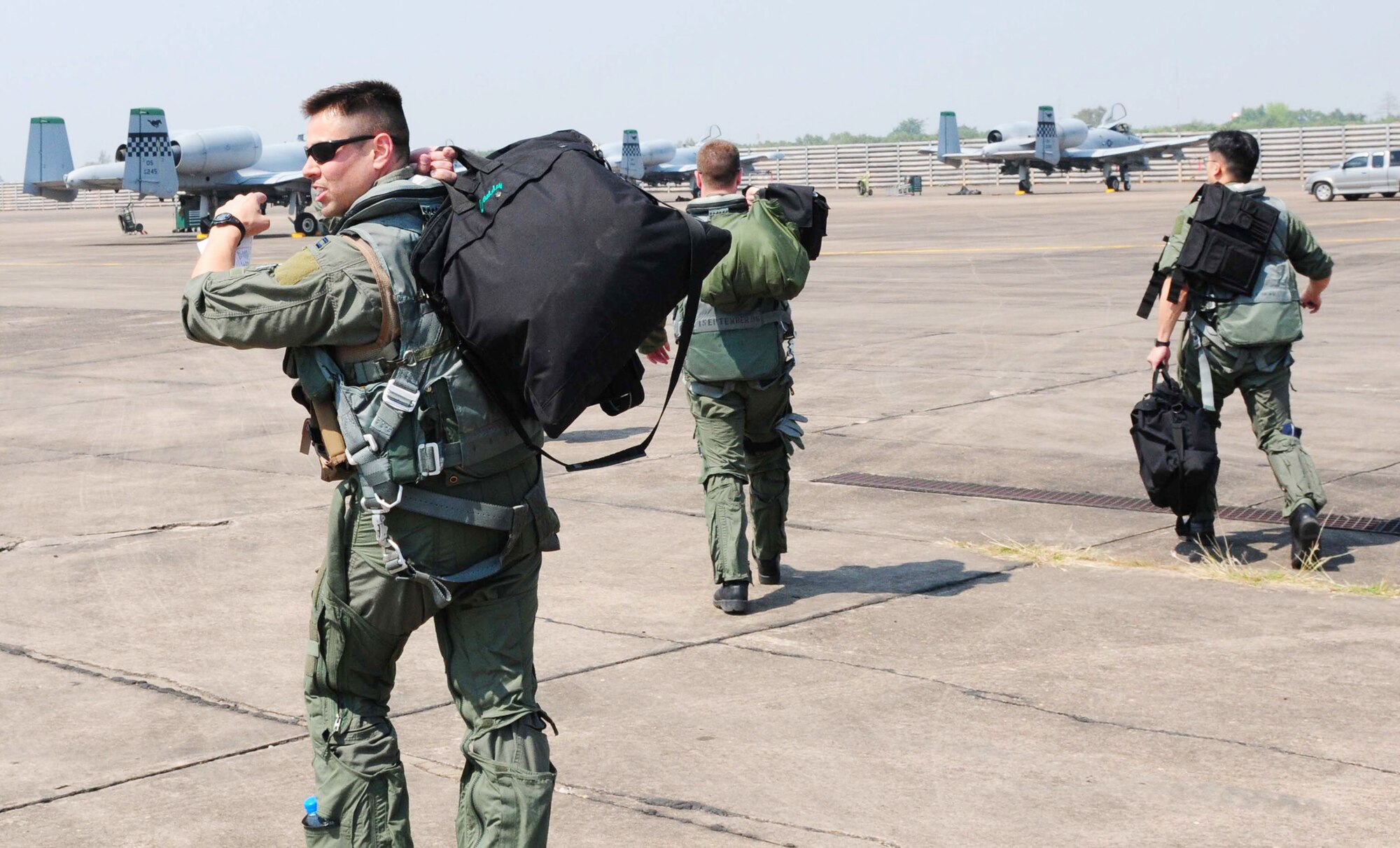 Airmen walk to their aircraft at Udon Thani Royal Thai Air Force Base, Thailand, March 4, 2010, before conducting the first of several planned missions as part of Cope Tiger 2010. The Airmen are participating in the annual, multilateral field training exercise involving the U.S. Air Force, Royal Thai Air Force and Army, and the Republic of Singapore Air Force March 1-12. The Airmen are from the 25th Fighter Squadron at Osan Air Base, South Korea. (U.S. Air Force photo/Capt. Genieve David)