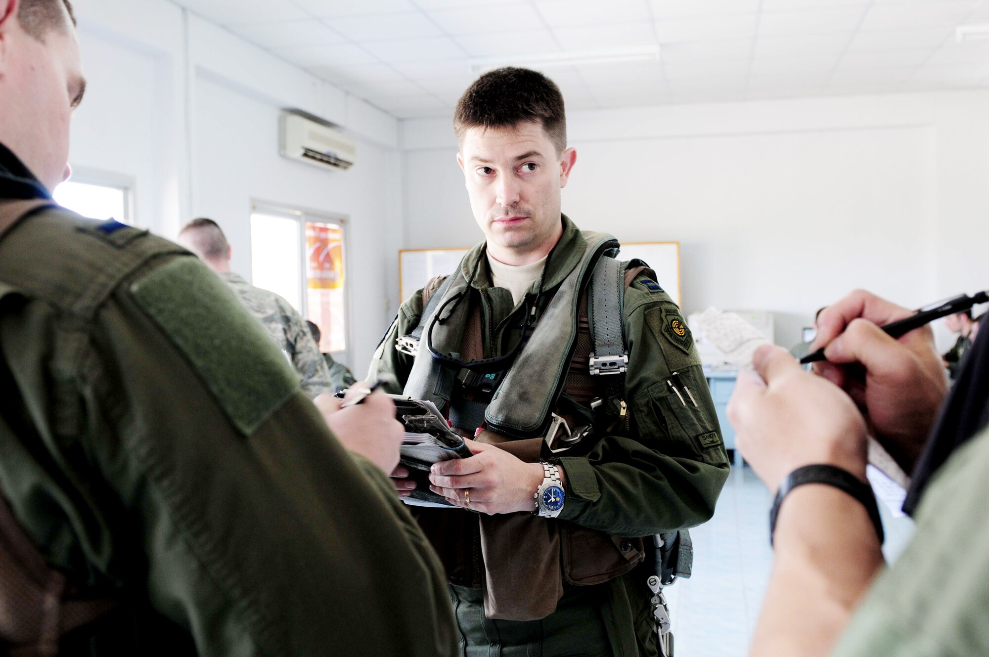 Capt. James Hunt reviews flight information with his fellow A-10 Thunderbolt II pilots prior to embarking on a four-ship training mission March 4, 2010, at Udon Thani Royal Thai Air Force Base, Thailand. Captain Hunt is deployed to the exercise from the 25th Fighter Squadron at Osan Air Base, South Korea. (U.S. Air Force photo/Capt. Genieve David)