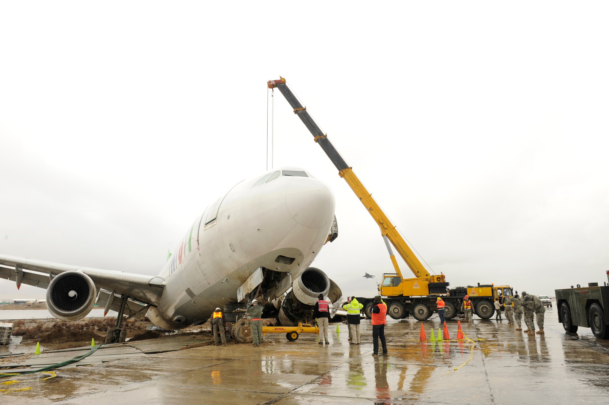 Airmen and contractors prepare to move an Airbus A300 after its crew preformed an emergency landing March 3, 2010, at Bagram Airfield, Afghanistan. (U.S. Air Force photo by/Tech. Sgt. Jeromy K. Cross)