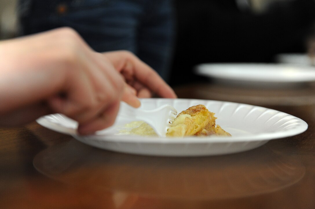 LANGLEY AIR FORCE BASE, Va. --  Senior Airman Jamie Starkey, 633d Force Support Squadron Raptor Café storeroom manager, cuts a piece of award-winning cinnamon cheesecake during a cook-off March 6.  The 633 FSS hosted the cook-off at the community center and plans to conduct more cooking contests in the futre. (U.S. Air Force photo/Senior Airman Zachary Wolf)