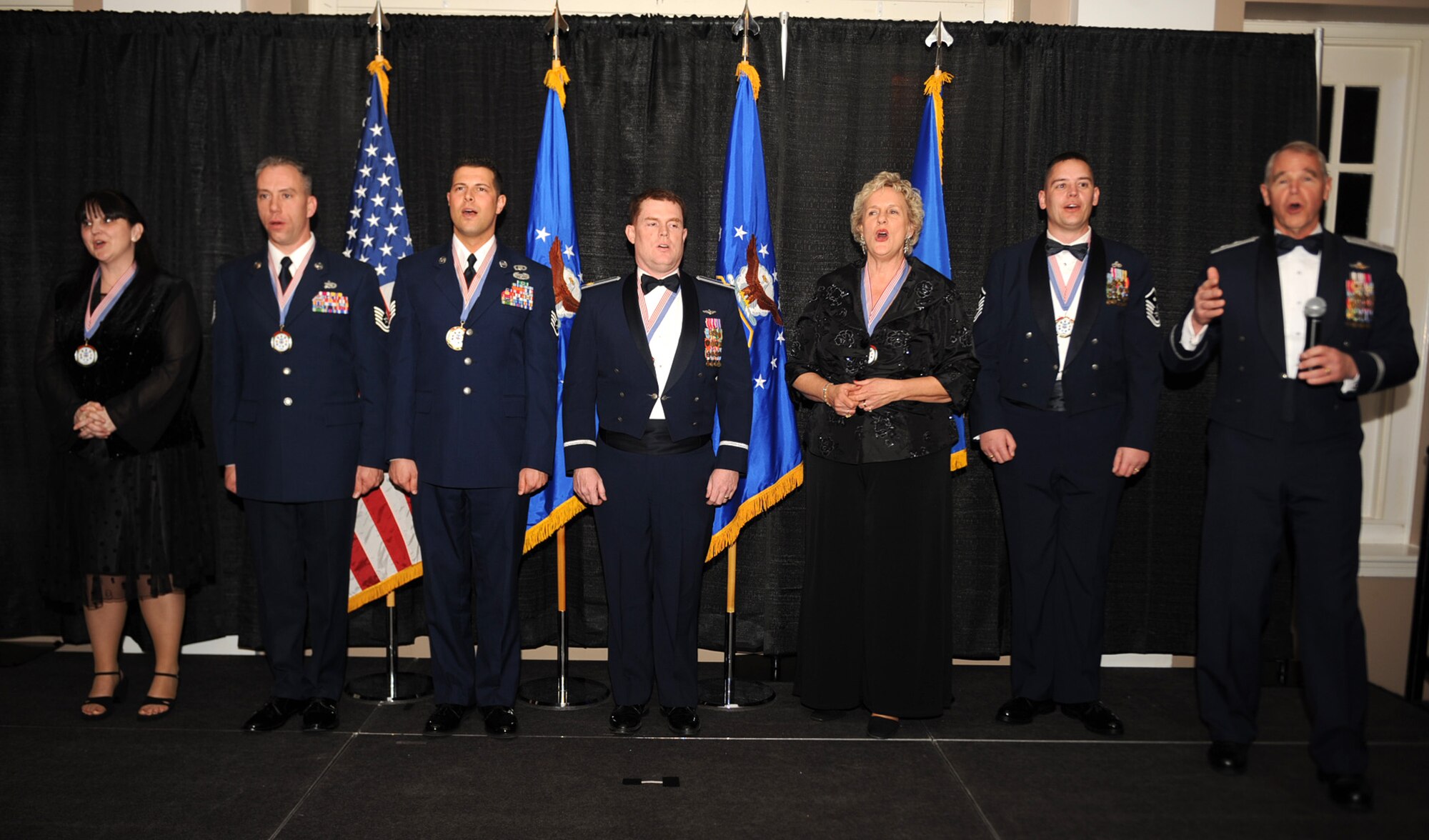 Maj. Gen. William Holland, 9th Air Force commander, joins the 9th AF Oustanding Performers of the Year in a rousing rendition of the Air Force song at the conclusion of the 9th AF Oustanding Performers of the Year Banquet March 4, 2010, at Seymour Johnson Air Force Base, N.C. (U.S. Air Force photo/Senior Airman Ciara Wymbs)