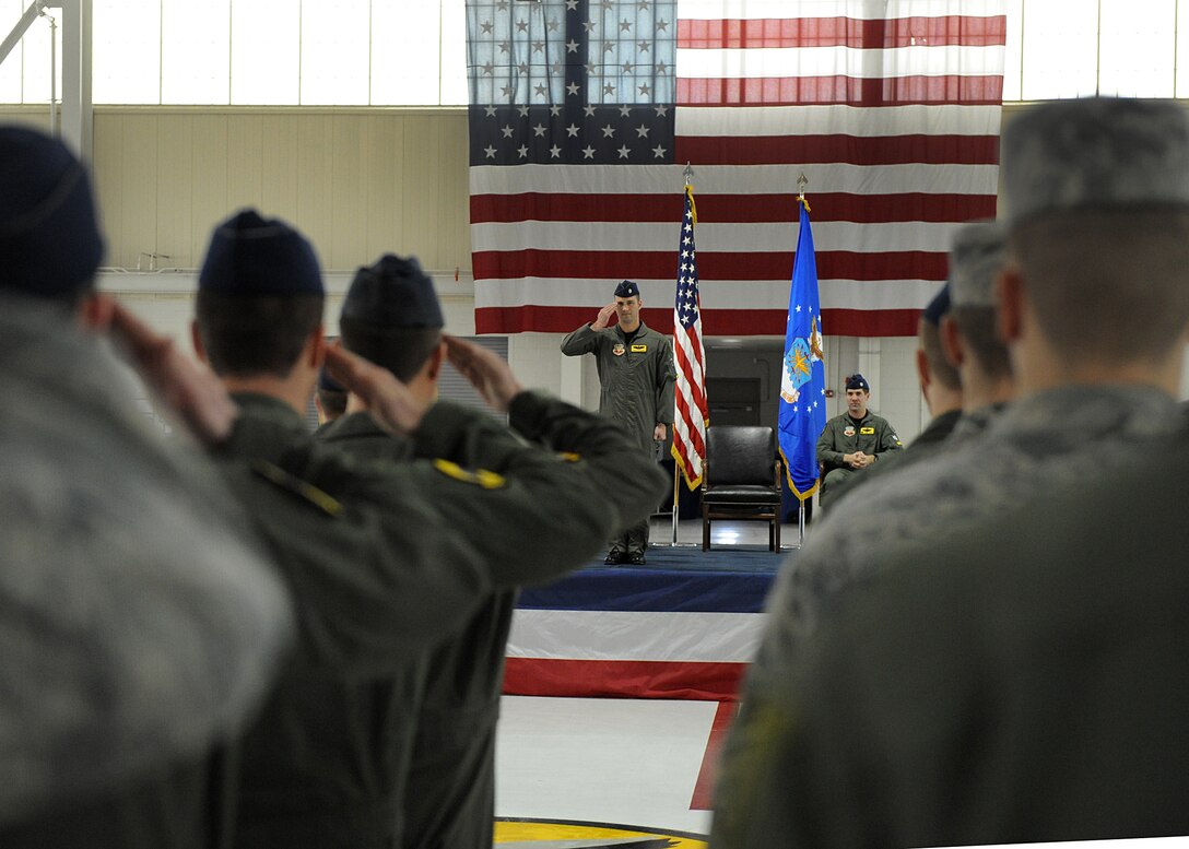 LANGLEY AIR FORCE BASE, Va. -- Lt. Col. Pete Fesler, new 27th Fighter Squadron commander, salutes members of his new squadron during the change-of-command ceremony March 5 in the 27 FS hangar.  Lt. Col. Lansing Pilch relinquished command to Colonel Fesler after serving nearly two years as commander.  (U.S. Air Force photo/Senior Airman Zachary Wolf)