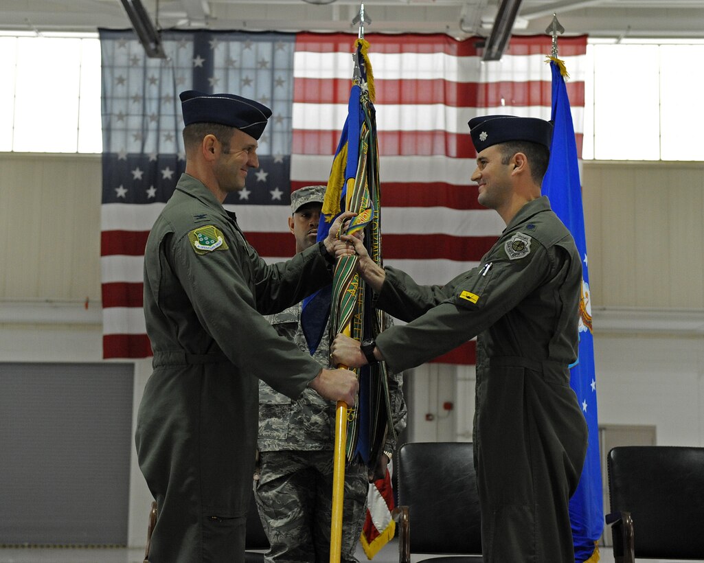 LANGLEY AIR FORCE BASE, Va. -- Col. Dirk Smith, 1st Operations Group commander, passes the guideon to Lt. Col. Pete Fesler, the new 27th Fighter Squadron commander,  March 5 in the 27 FS hangar.  Lt. Col. Lansing  Pilch relinquished command to Colonel Fesler after serving nearly two years as commander.  (U.S. Air Force photo/Senior Airman Zachary Wolf)