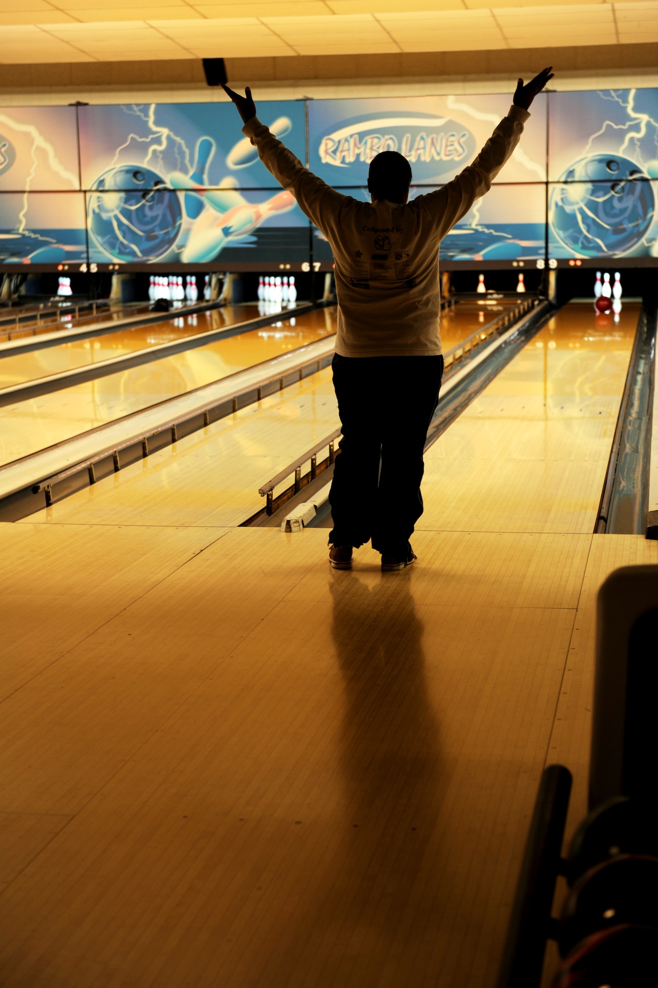 A woman celebrates prior to making a spare during the Bowling for Haiti fundraiser at the bowling center, Ramstein Air Base, Germany, March 6, 2010. The event collected over two thousand dollars that will be given to The American Red Cross Haiti Relief and Development Fund. (U.S. Air Force photo by Tech. Sgt. Sarayuth Pinthong)
