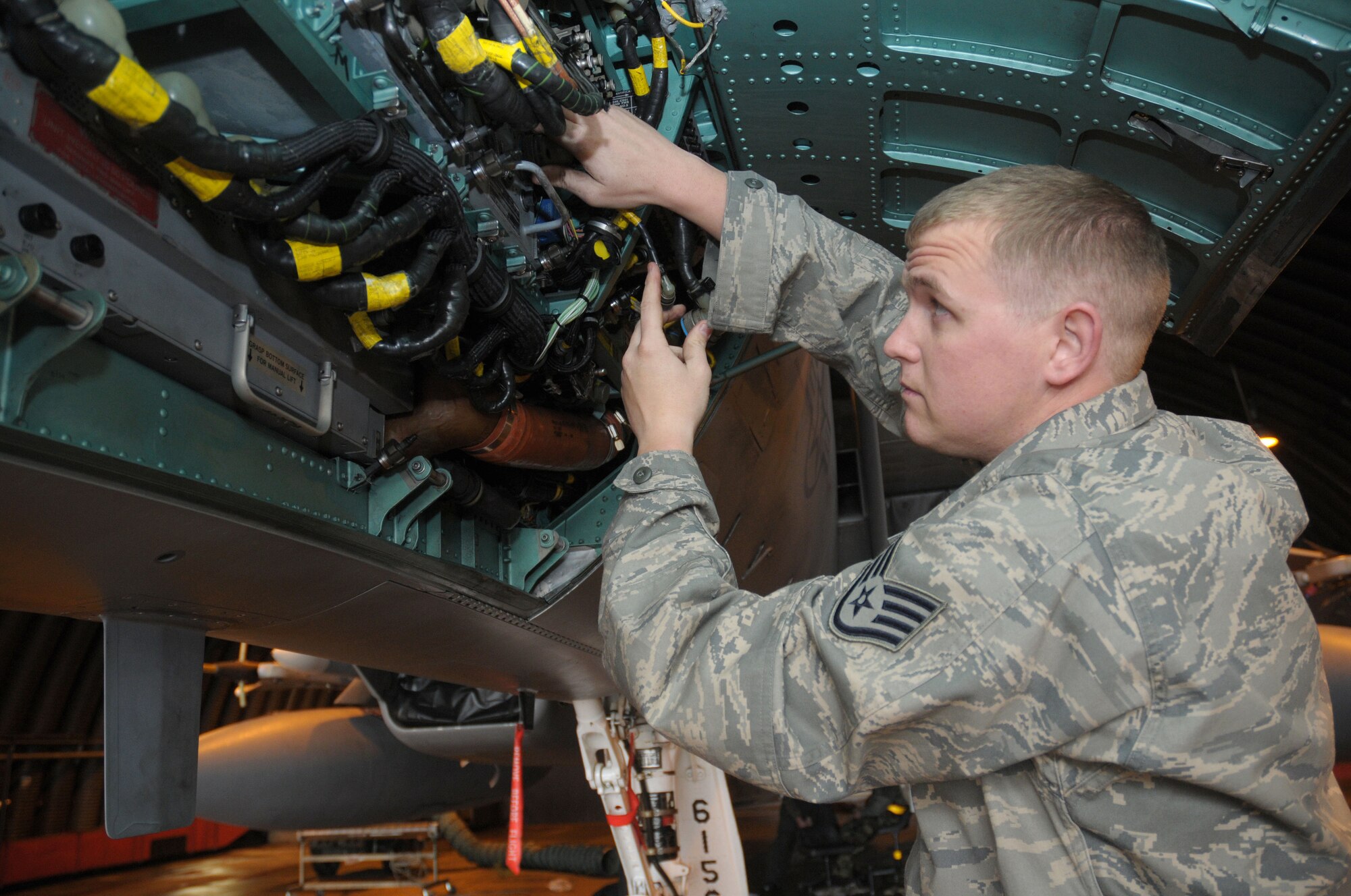 Staff Sgt. Barry Wiles, 748th Aircraft Maintenance Squadron, 493rd Aircraft Maintenance Unit Avionics technician, installs a heads-up display data processor on an F-15C Strike Eagle jet at RAF Lakenheath, England, Feb. 25, 2010. The data processor displays heading, attitude, air speed and other pertinent information to the pilot.  (U.S. Air Force photo/Staff Sgt. Connor Estes)