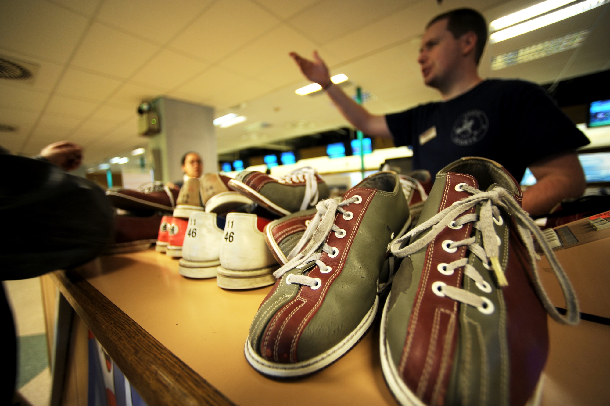 A U.S. military member returns shoes after participating with the Bowling for Haiti fundraiser at the bowling center, Ramstein Air Base, Germany, March 6, 2010. The event collected over two thousand dollars that will be given to The American Red Cross Haiti Relief and Development Fund. (U.S. Air Force photo by Tech. Sgt. Sarayuth Pinthong)