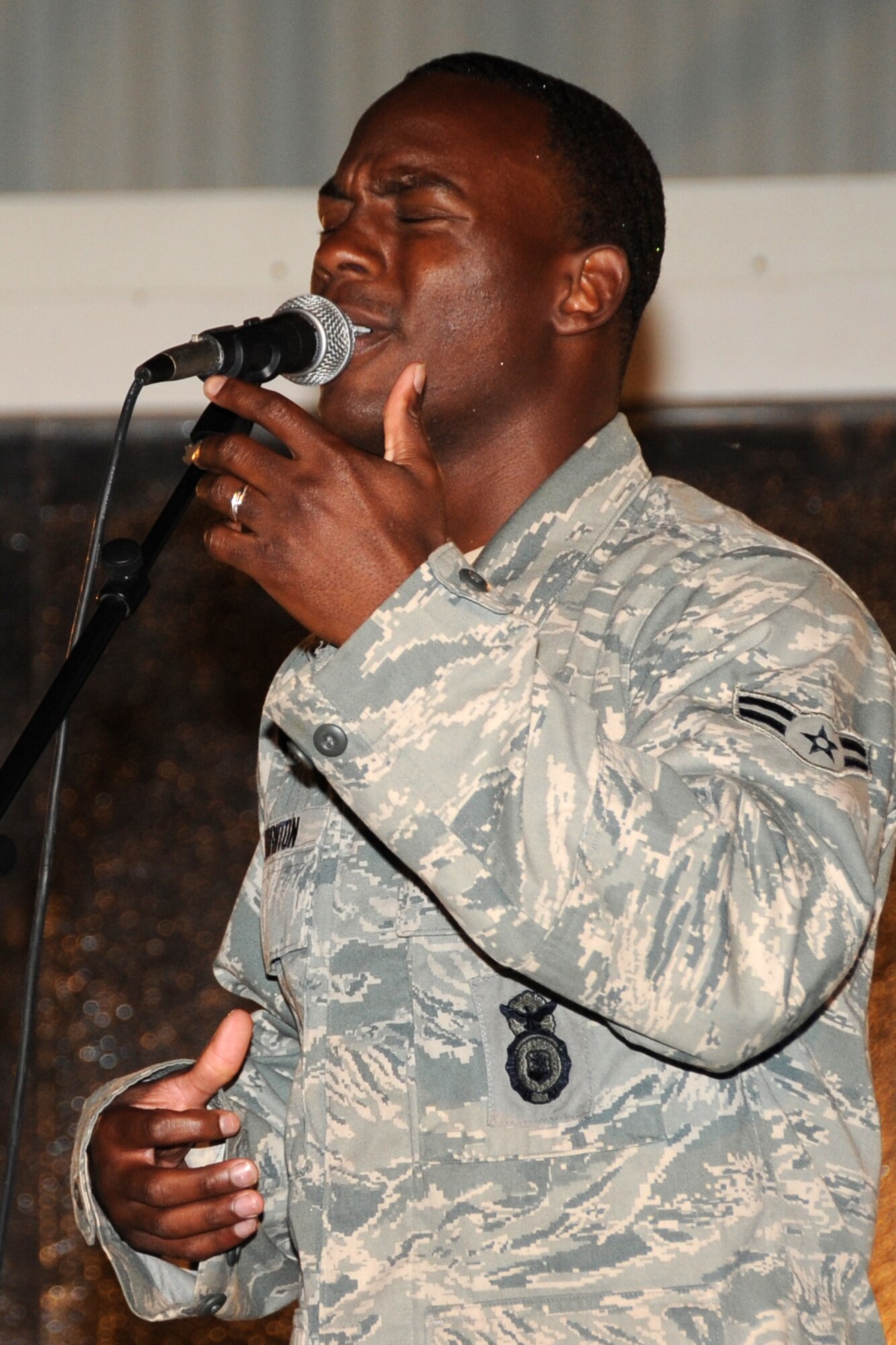 Airman 1st Class Dominic Thoraton, 380th Security Forces Squadron member, sings during the "Gospel Explosion" at an undisclosed location in Southwest Asia on March 6, 2010. Members of various worship services musical groups joined together for a concert with special guest (Ch.) Maj. Gen. Cecil Richardson, Air Force Chief of Chaplains, speaking. The 380th Air Expeditionary Wing supports Operations Iraqi Freedom and Enduring Freedom and the Combined Joint Task Force-Horn of Africa. The 380th AEW is comprised of four groups and 12 squadrons and the wing's deployed mission includes air refueling, surveillance and reconnaissance in support of overseas contingency operations in Southwest Asia. (U.S. Air Force photo/Senior Airman Jenifer H. Calhoun/Released)