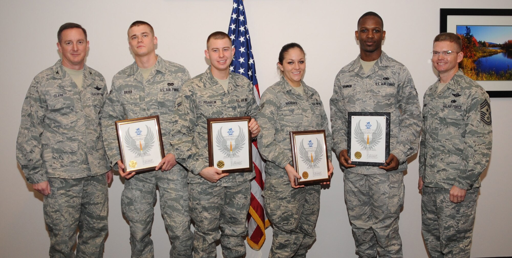 Diamond Sharp award winners Airman 1st Class Josh Bauer, 27th Special Operations Civil Engineer Squadron, Airman 1st Class Justin Pasarcik, 27th Special Operations Logistics Readiness Squadron, Senior Airman Delia Marchick, 27th Special Operations Medical Group and Airman 1st Class Marcus Shannon, Special Operations Maintenance Operations Squadron, stand with Col. Stephen Clark (left), 27th Special Operations Wing commander, and Chief Master Sgt. William Turner (right), 27 SOW command chief following the monthly Diamond Sharp Breakfast at The Landing Zone at Cannon Air Force Base, N.M., March 5. Diamond Sharp Airmen are selected monthly by Cannon's first sergeants to recognize Airmen who exemplify Air Force standards of conduct and performance. (U.S. Air Force photo by Airman 1st Class Maynelinne De La Cruz)