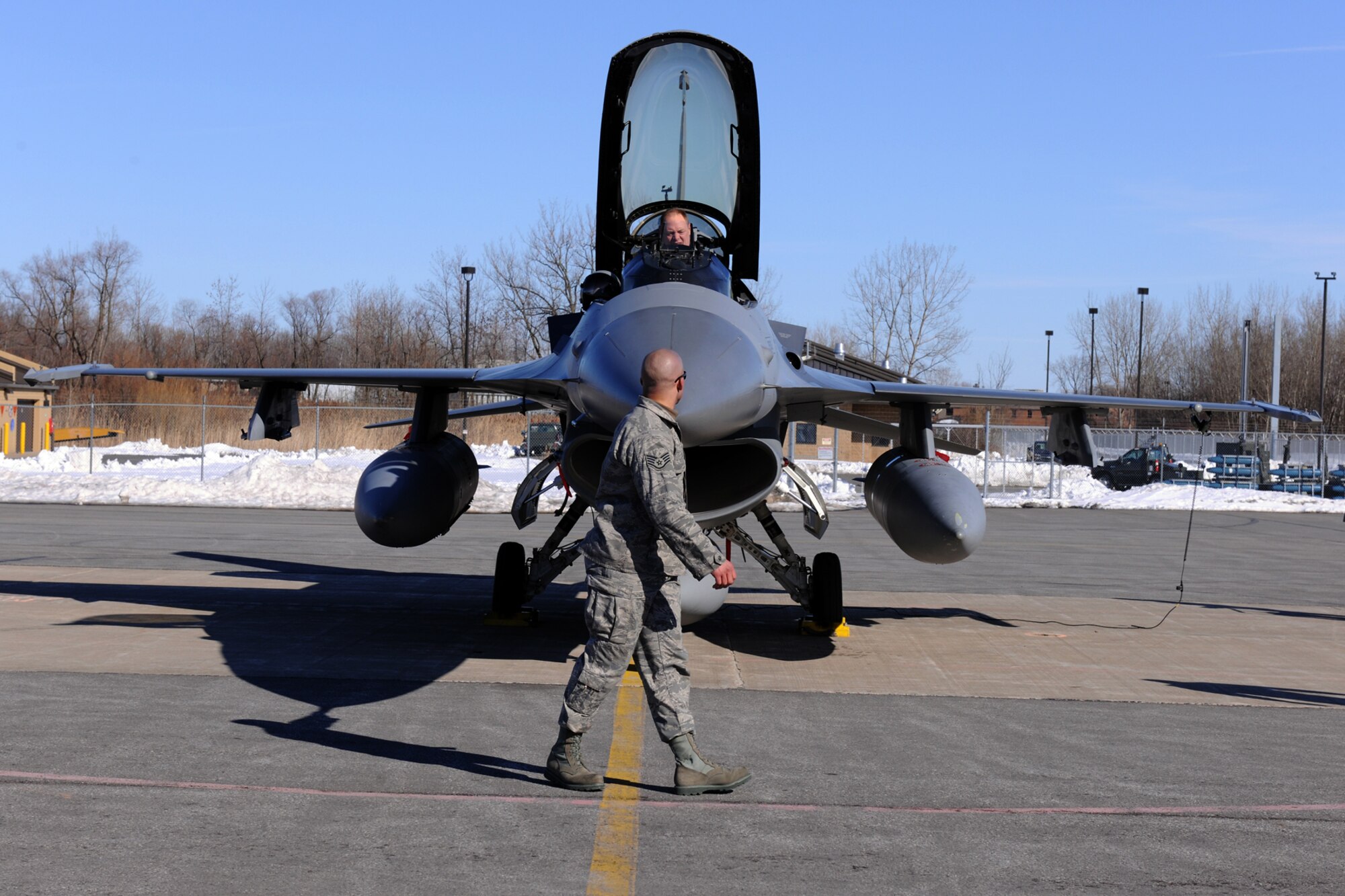 174th Fighter Wing Commander Colonel Kevin W. Bradley prepares for the final flight of the F-16 from Hancock Field Air National Guard Base as Crew Chief Staff Sgt. Preston J. Cox does a pre-flight walk around for the final time. The 174th Fighter Wing has converted to the MQ-9 Reaper and began flying 24/7 operations in support of Operation Enduring Freedom on 1 December 2009. (US Air Force photo by Staff Sgt James N. Faso II/Released) 