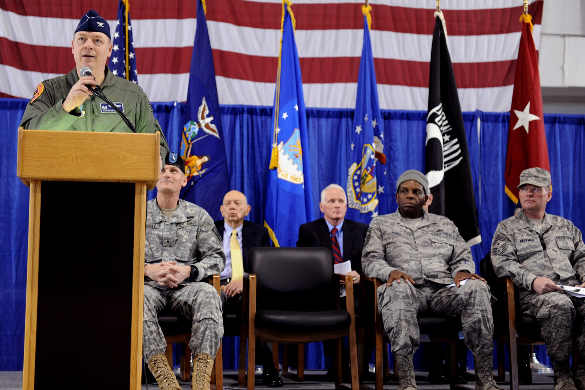 174th Fighter Wing Commander Colonel Kevin W. Bradley speaks to the 174th Fighter Wing and assembled guests about the departure of the final two F-16's at Hancock Field Air National Guard Base on Saturday, 6 March 2010.The 174th Fighter Wing has converted to the MQ-9 Reaper and began flying 24/7 operations in support of Operation Enduring Freedom on 1 December 2009. (US Air Force Photo by Staff Sgt James N. Faso II/Released)
