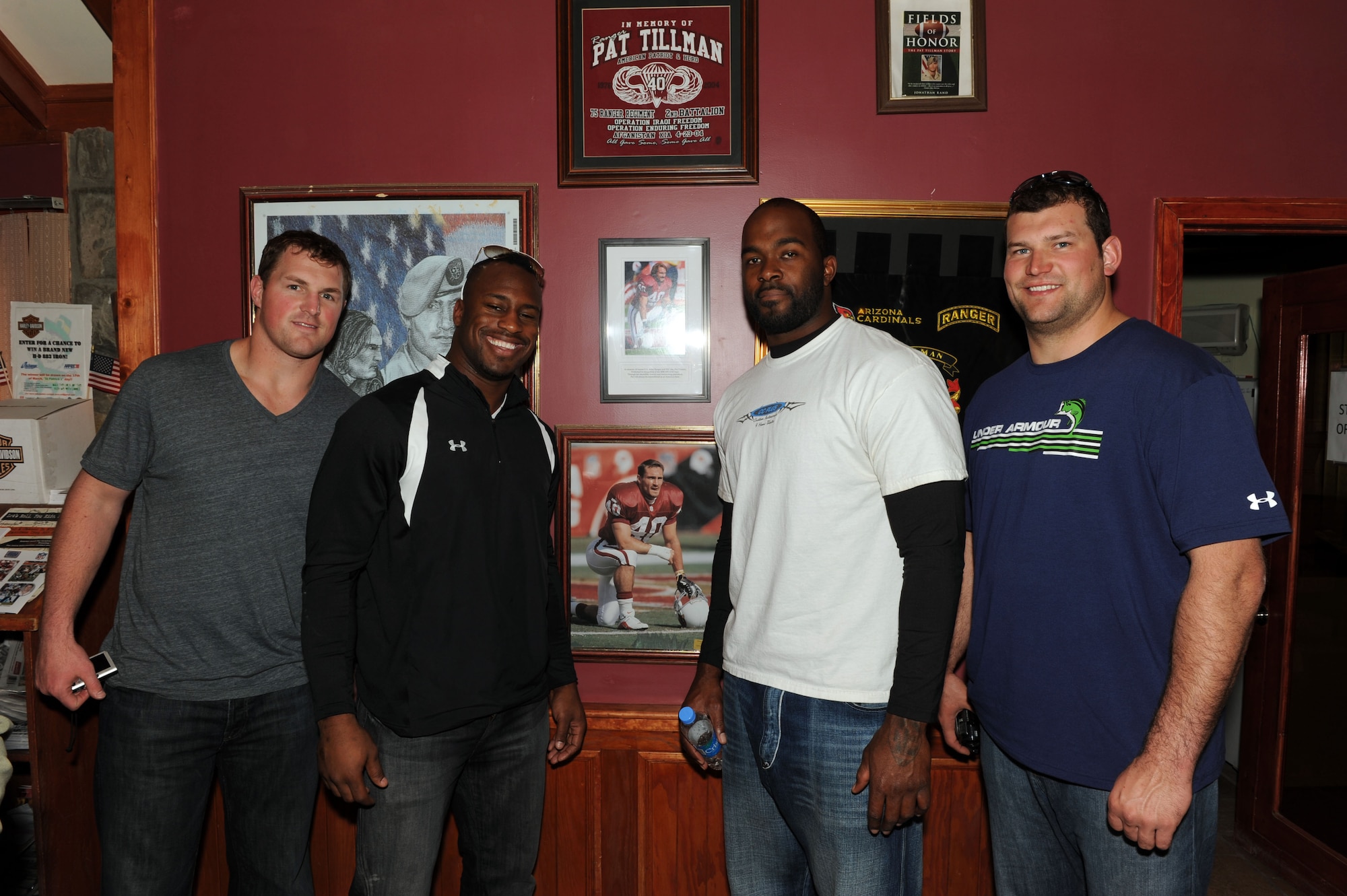 Jason Witten (left), Dallas Cowboys, Vernon Davis, San Francisco 49ers, Mario Williams, Houston Texans and Joe Thomas, Cleveland Browns, stop for a photograph at the Pat Tillman USO on Bagram Airfield, March 5, 2010. The National Football League players are on a USO-sponsored tour of the U.S. Central Command area of operations. (U.S. Air Force photo/Staff Sgt. Richard Williams)