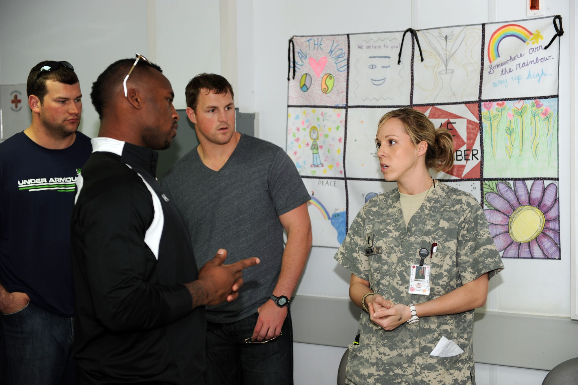 U.S. Air Force 1st Lt. Candice Owen, 455th Expeditionary Medical Group/Task Force Medical clinical nurse, explains basic hospital procedures to National Football League players during a visit to the Craig Joint Theater Hospital on Bagram Airfield, March 5, 2010. The NFL players are on a USO-sponsored tour of the U.S. Central Command area of operations. (U.S. Air Force photo/Staff Sgt. Richard Williams)