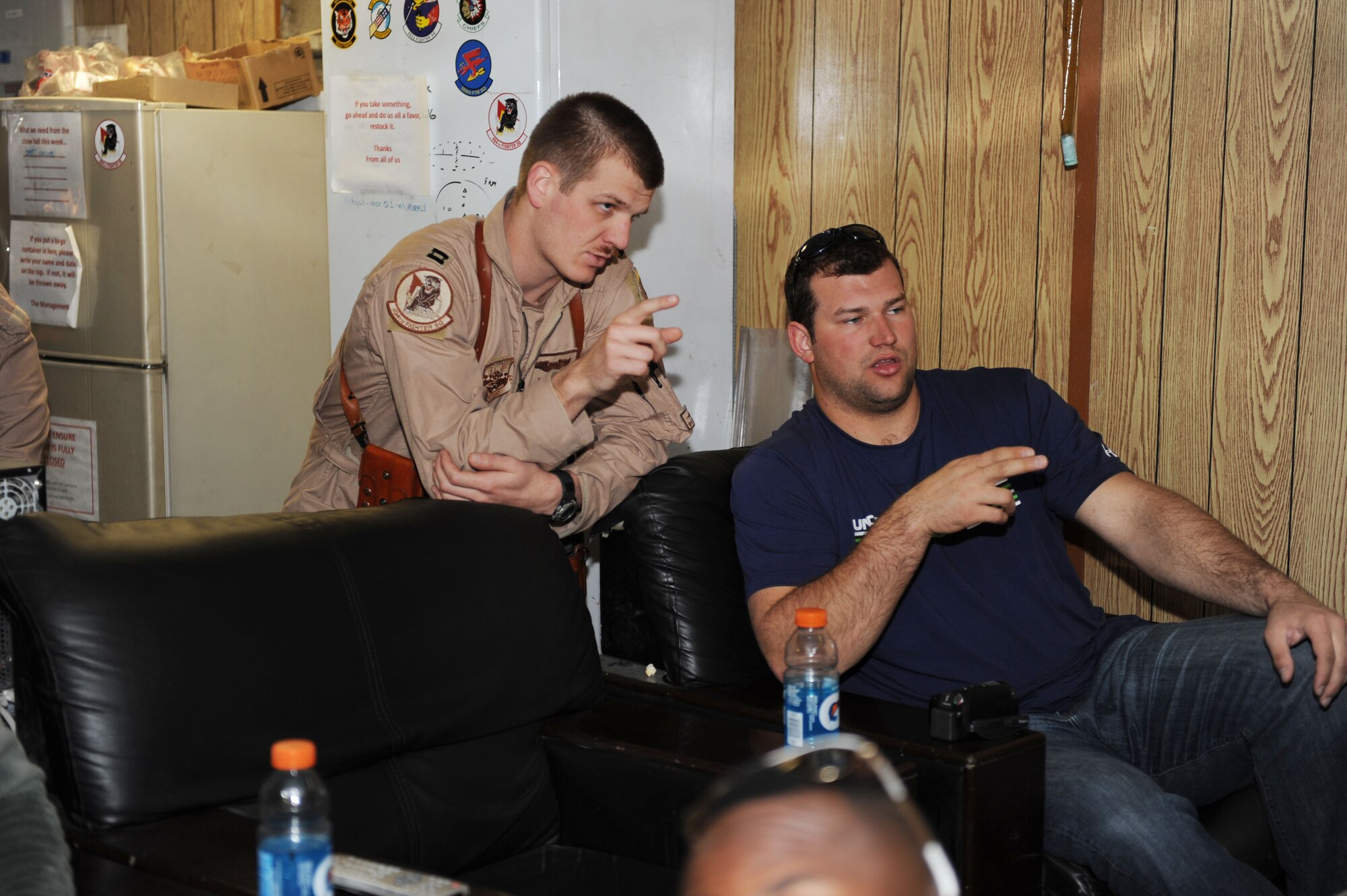 U.S. Air Force Capt. Robert, 494th Expeditionary Fighter Squadron F-15E pilot, explains aircraft weapons systems operations to Joe Thomas of the Cleveland Browns during a National Football League player visit to Bagram Airfield, March 5, 2010. The NFL players are on a USO-sponsored tour of the U.S. Central Command area of operations. (U.S. Air Force photo/Staff Sgt. Richard Williams)
