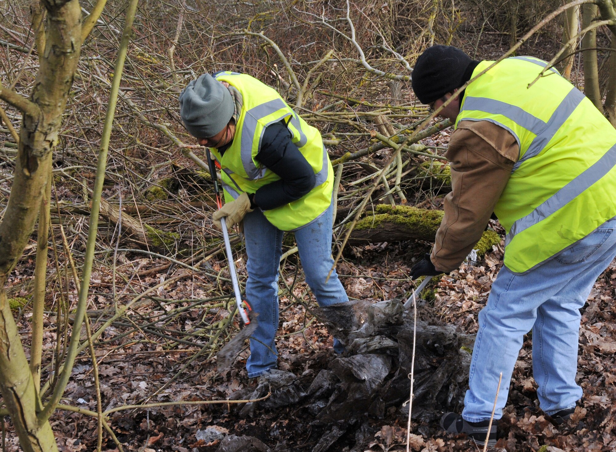 RAF MILDENHALL, England – Tech. Sgts. Cheron Nieves (left), 100th Logistics Readiness Squadron, and Jarrod Gnau, 100th Civil Engineer Squadron, combine efforts to pick up a large pile of litter in Red Lodge’s heath March 6. The technical sergeants were two of more than 30 RAF Mildenhall volunteers who assisted local constables and villagers in the cleanup. (U.S. Air Force photo/Tech. Sgt. Kevin Wallace)