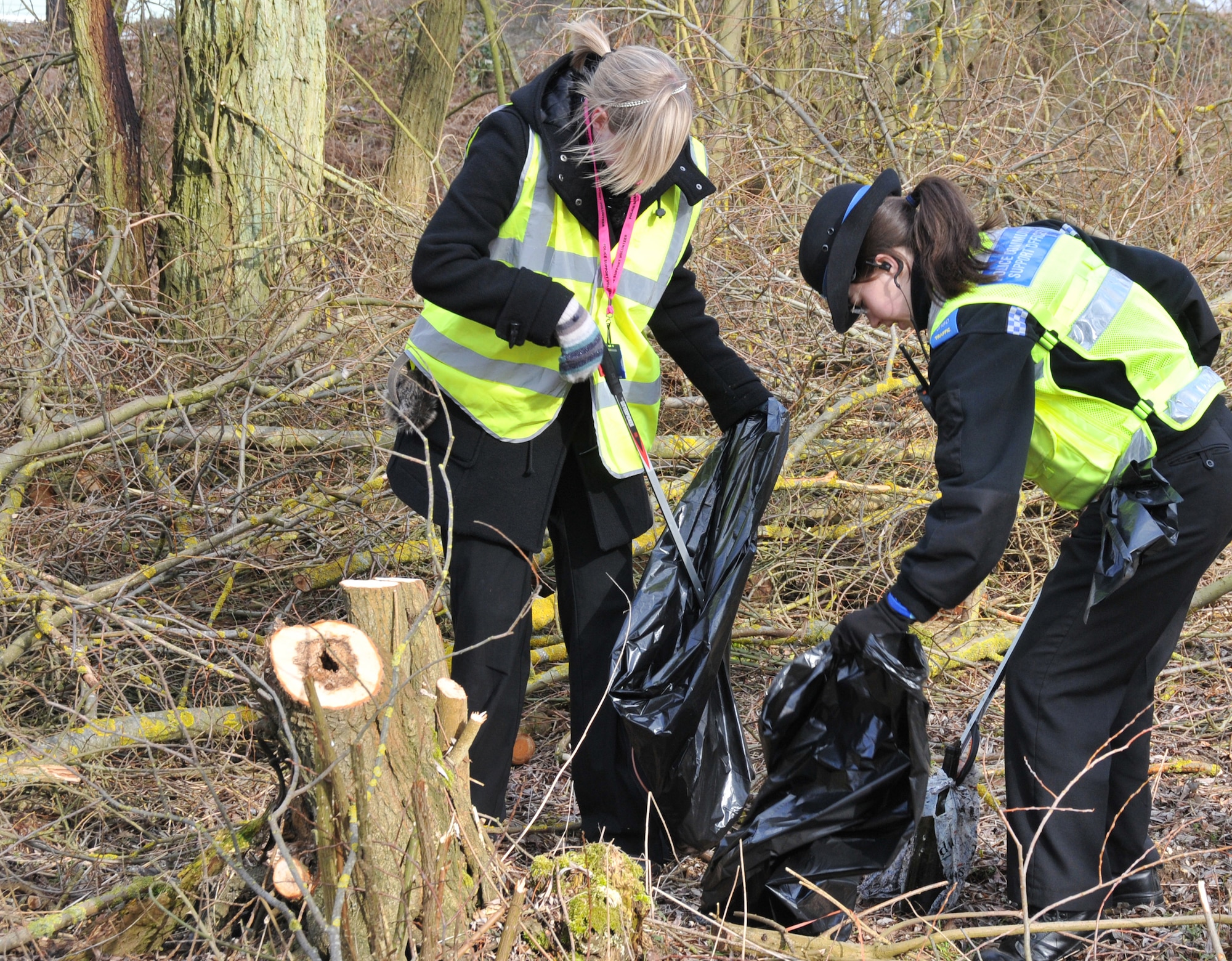 RAF MILDENHALL, England – Becky Simpson (right), a police community support officer, and Lucy Ellis, volunteer, remove a pile of litter in Red Lodge March 6. About 10 constables joined more than 30 RAF Mildenhall volunteers and local villagers to undertake the effort. (U.S. Air Force photo/Tech. Sgt. Kevin Wallace)