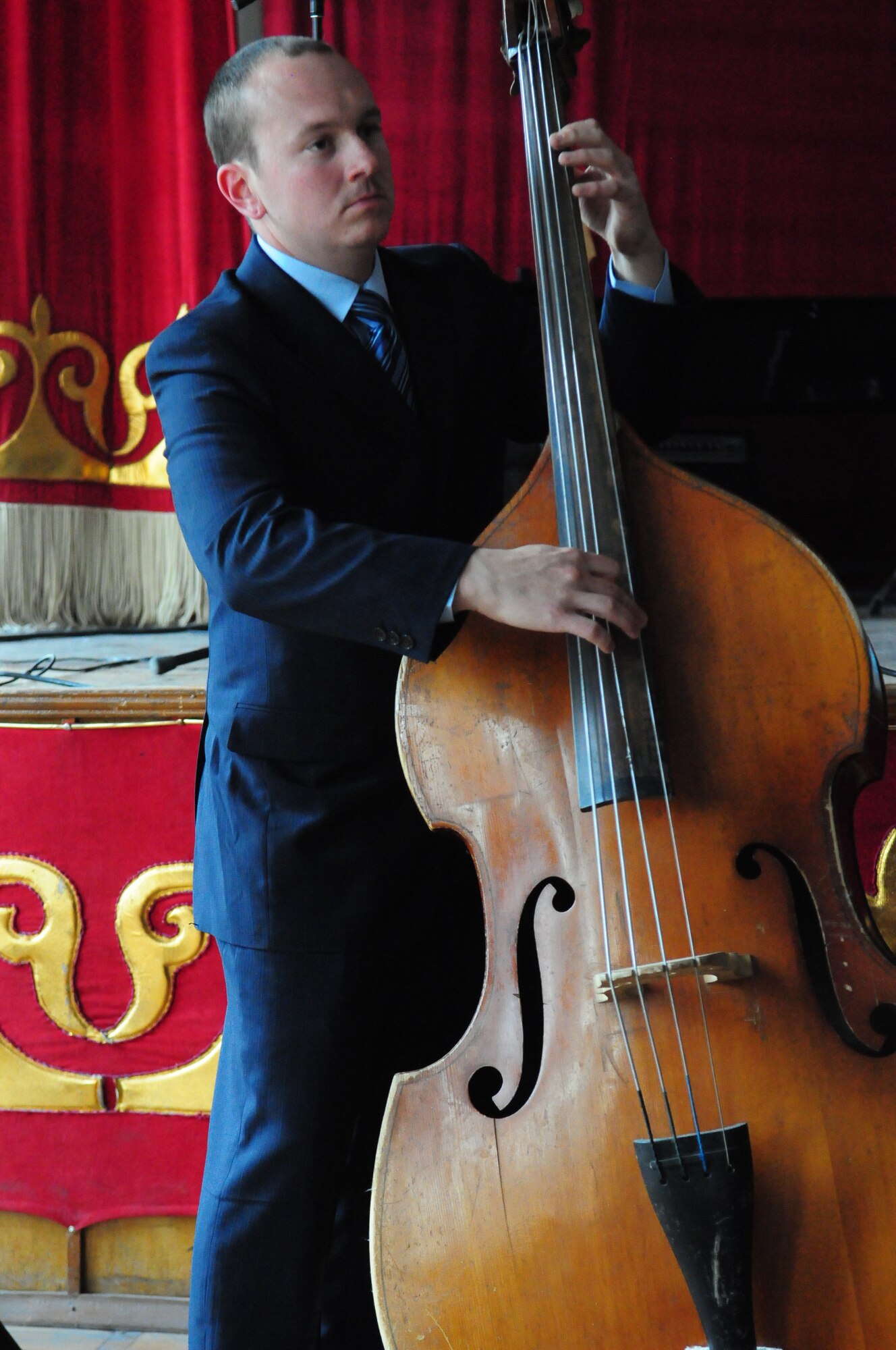 Airman 1st Class Darren King, member of the U.S. Air Forces Central Public Affairs band “Reserve Generation,” plays an upright bass during a concert at the Kurenkeyev College of Music, Bishkek, Kyrgyzstan, March 5, 2010.  When an unexpected power outage knocked out his electrical bass, Airman King was provided the instrument by the College faculty, and continued performing to the delight of the audience. (U.S. Air Force photo/Senior Master Sgt. Mike Litsey/Released)