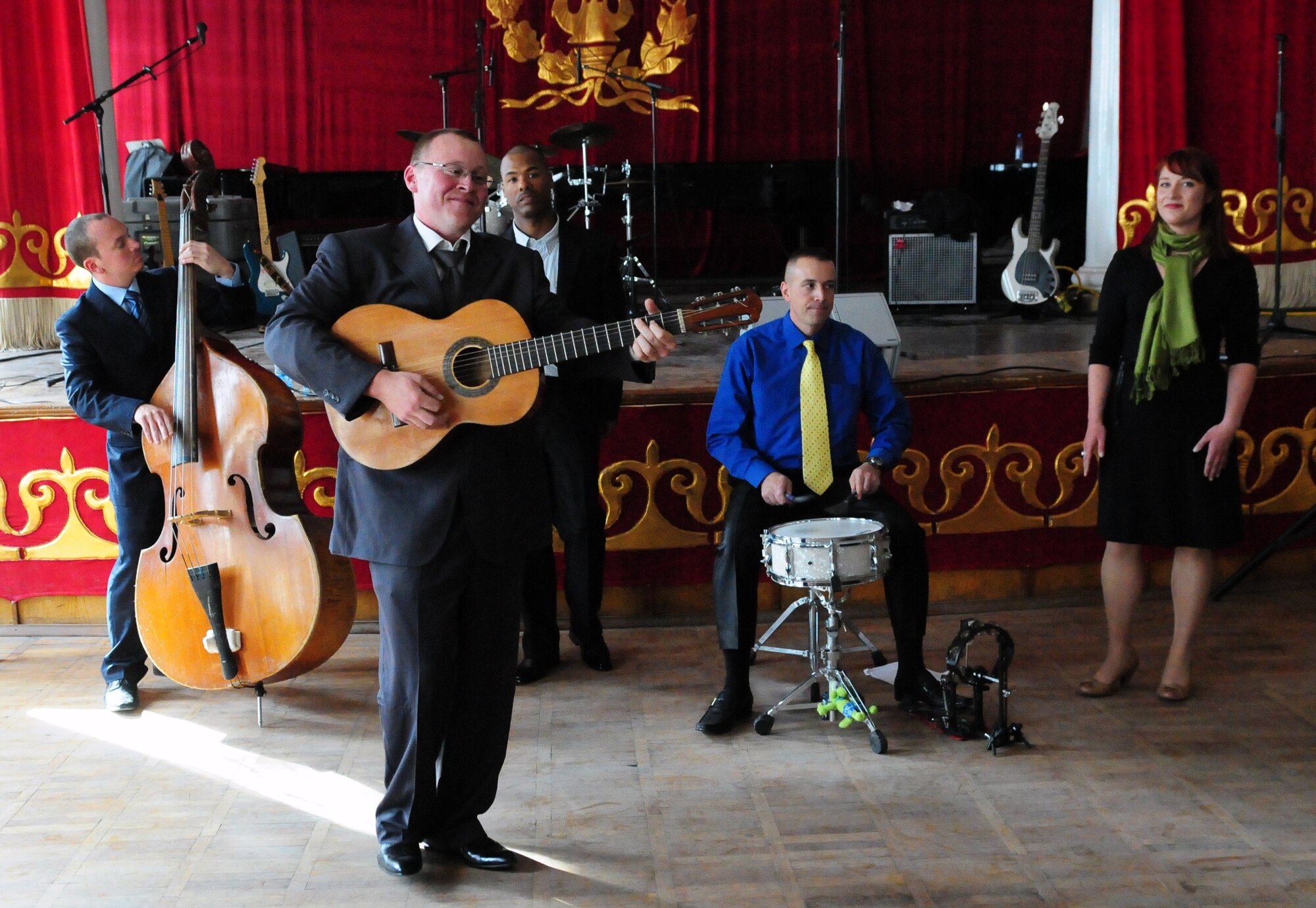 U.S. Air Forces Central Public Affairs band “Reserve Generation” performs at the Kurenkeyev College of Music, Bishkek, Kyrgyzstan, March 5, 2010. When an unexpected power outage knocked out their electrical equipment, members of the band continued their concert to the delight of the audience. (U.S. Air Force photo/Senior Master Sgt. Mike Litsey/Released)