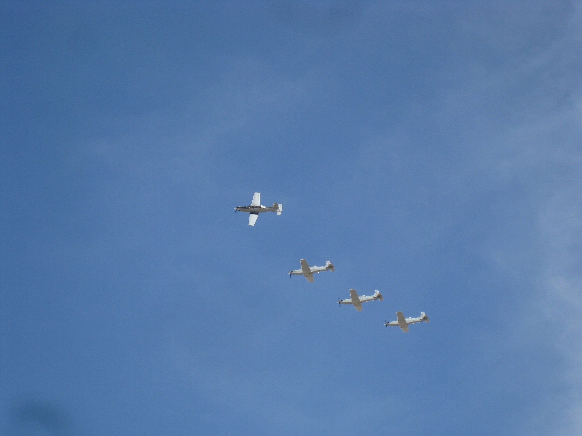 T-6A trainer aircraft pilots fly above the Iraqi Air Force College near Tikrit, Iraq, Dec. 16. The four-ship formation was the first of 15 Texans to be delivered to the college for use in an 18-month pilot training course – part of a three-year Iraqi Air Force commissioning program. (courtesy photo)