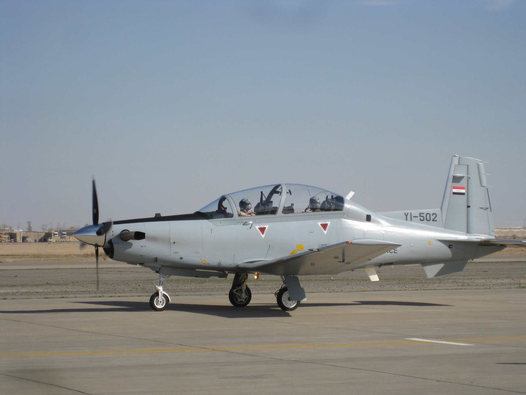 A  T-6A aircrew taxis at the Iraqi Air Force College near Tikrit, Iraq, Dec. 16. The aircraft will be flown during the 18-month pilot training course being developed by Airmen of the 52nd Expeditionary Flying Training Squadron. (courtesy photo)