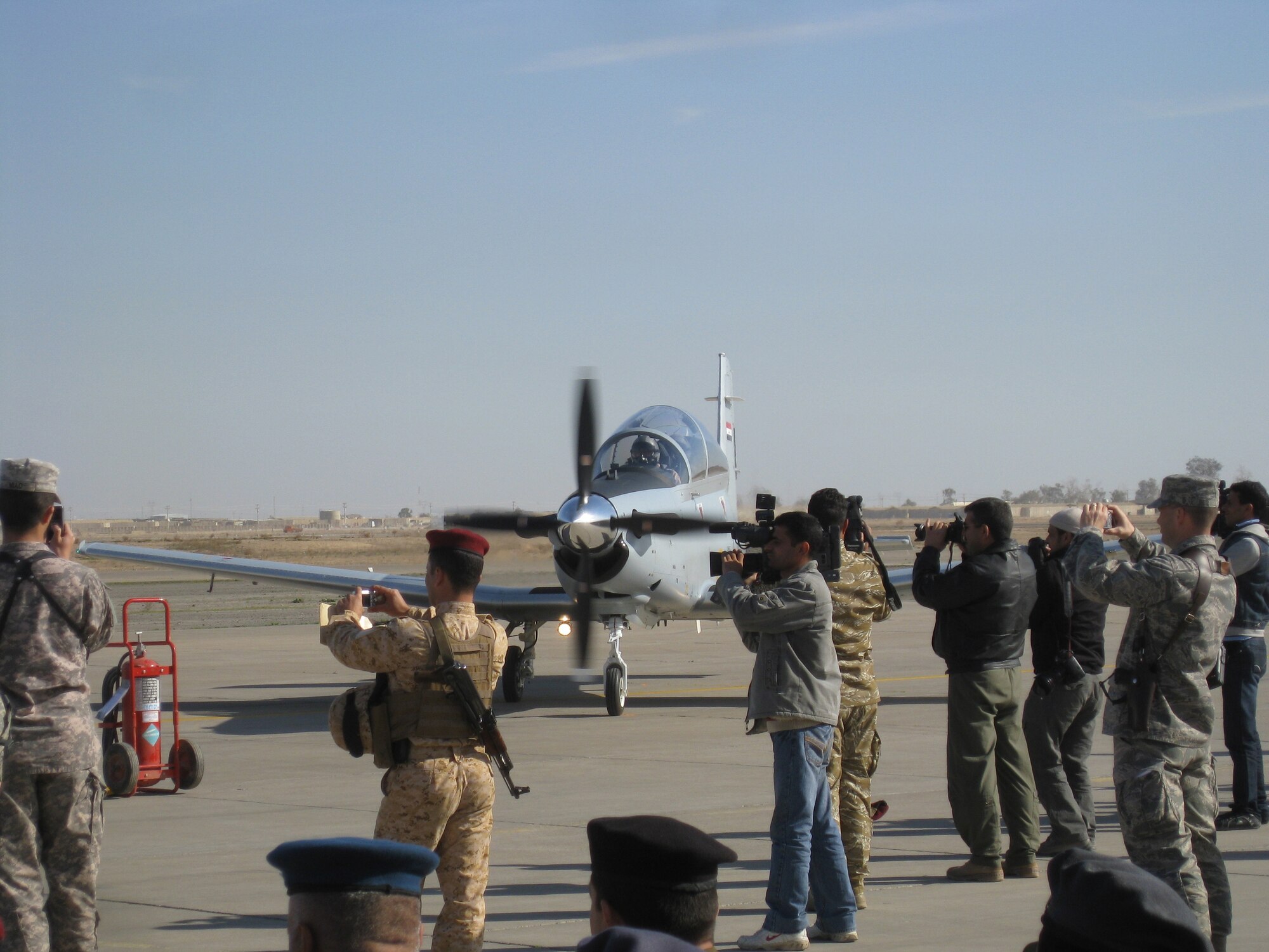 International media photographs the first four T-6A Texan II aircraft arriving at the Iraqi Air Force College in Tikrit, Iraq, Dec. 16. The college now has eight of a projected 15 aircraft that will propel the Iraqi Air Force into the future. (courtesy photo)
