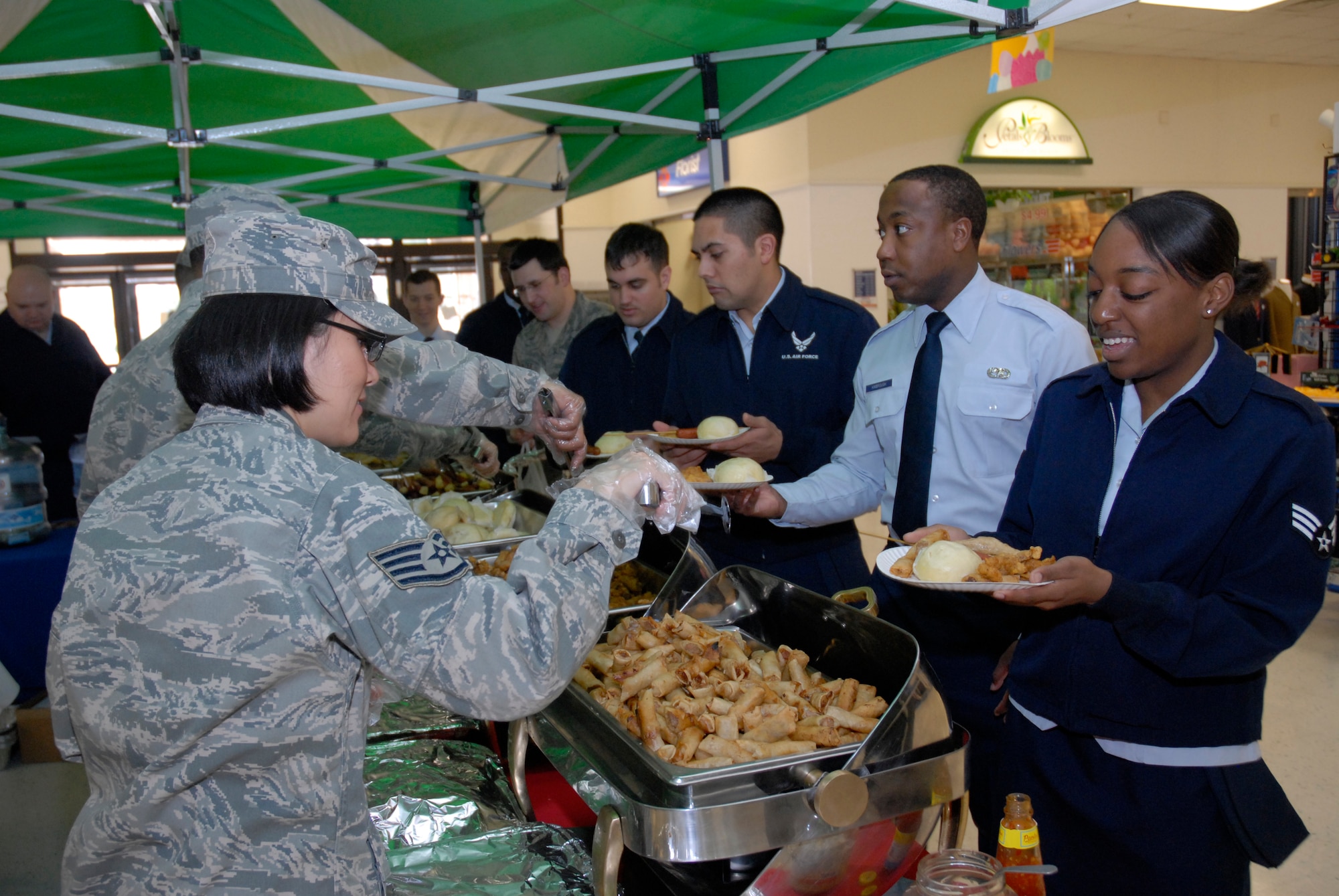 KUNSAN AIR BASE, Republic of Korea -- Volunteers for the Air Force Assistance Fund campaign serve food to members of the 8th Fighter Wing during the AFAF campaign kick-off here March 8. The AFAF committee hosted a free lunch for members of the Wolf Pack and also explained the importance of donating to the AFAF. (U.S. photo/Staff Sgt. Darnell T. Cannady)