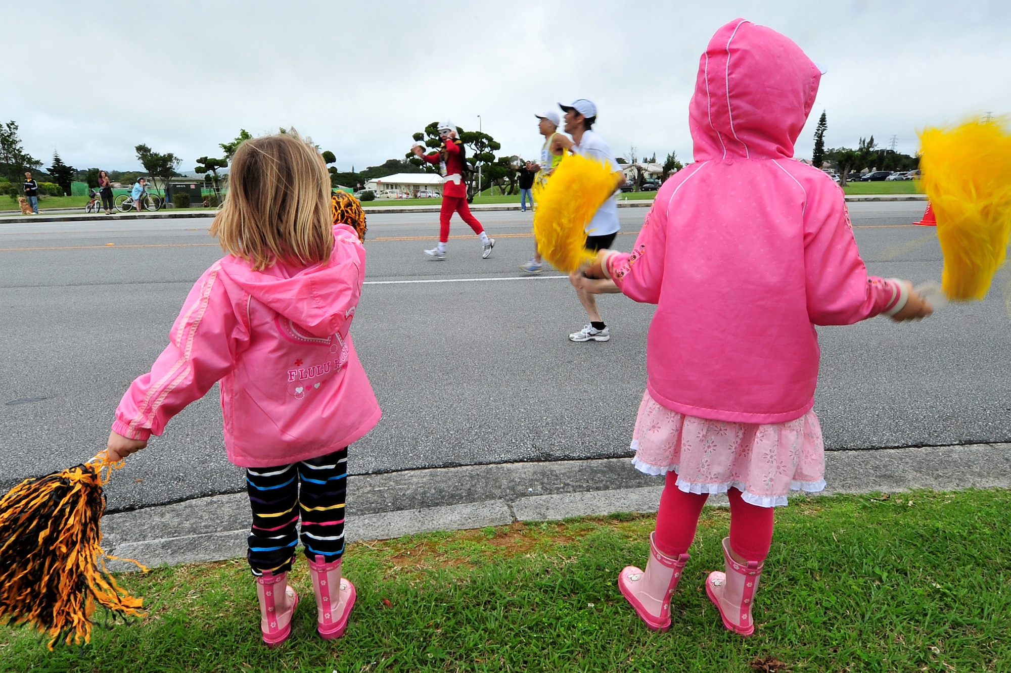Young kids cheered on Americans and Okinawans participating in the Okinawa Marathon March 7 at Kadena Air Base, Japan. Team Kadena volunteers encouraged and provided water to runners as they participated in the Kadena portion of the marathon. The marathon runs through nine different cities,towns,and villages in central Okinawa at a distance of 26.4 miles. The marathon aims to encourage people to enjoy running and increase their fitness level throughout Okinawa.  (U.S. Air Force photo/Tech. Sgt. Rey Ramon)          