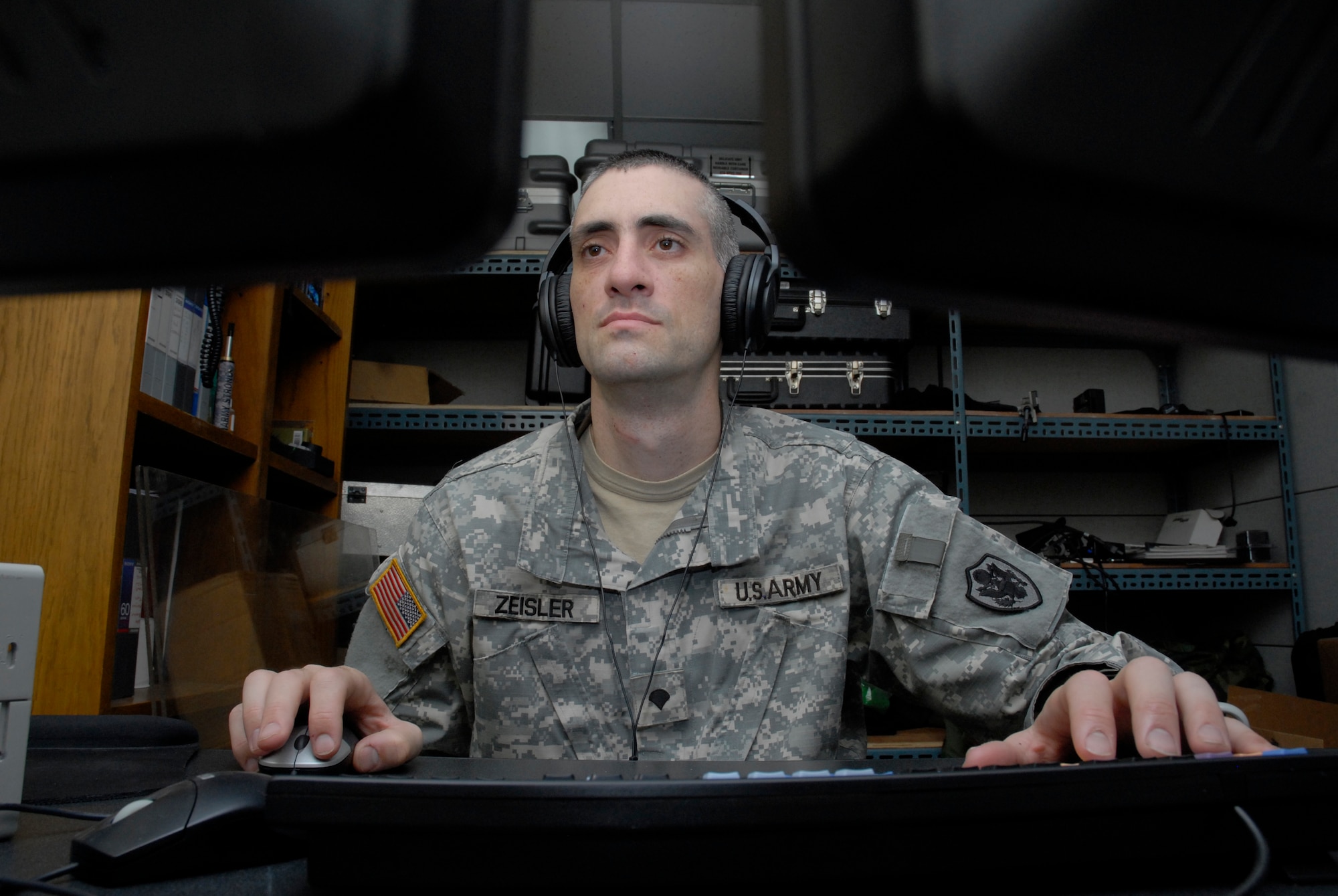 KUNSAN AIR BASE, Republic of Korea -- Army Spc. Brian Zeisler, Broadcaster for the American Forces Network, uses a media composer to finish the production of an AFN spot, or commercial, here. The AFN spots and video productions are a valuable tool for getting the commander's messages to Wolf Pack members. Spots inform Wolf Pack members about various events that happen on base, update changes to policies and regulations, and highlight Wolf Pack accomplishments to the entire peninsula. (U.S. photo/Staff Sgt. Darnell T. Cannady)