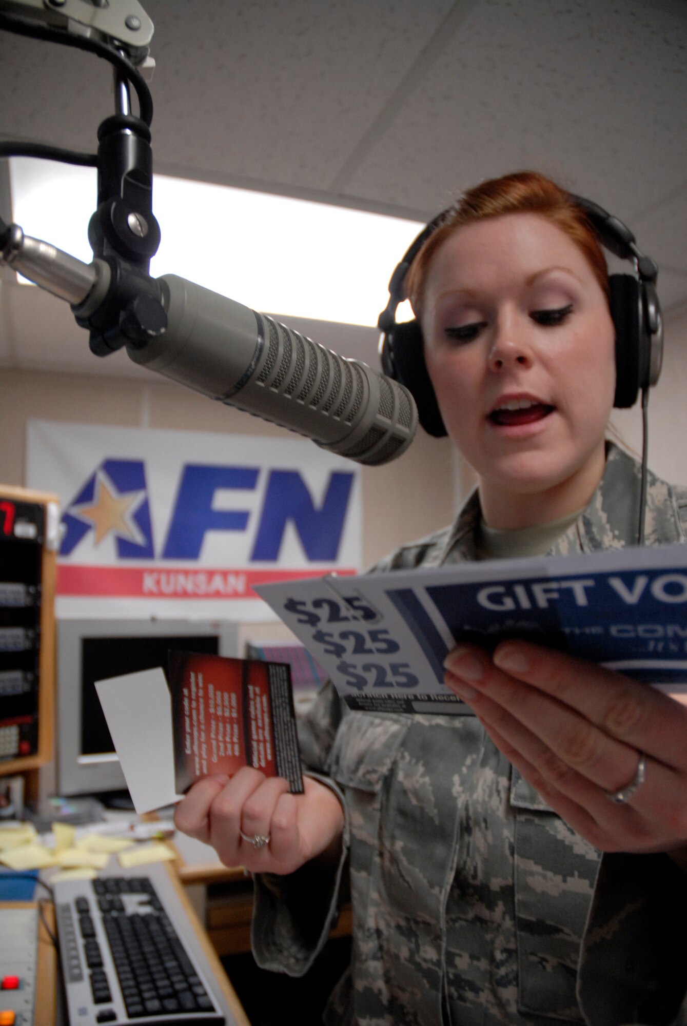 KUNSAN AIR BASE, Republic of Korea -- Senior Airman Melissa Hay, broadcast journalist for American Forces Network, explains the prizes her listening audience can receive from her trivia contest during her morning radio show here. The radio show is also a valuable tool for getting the commander's message to the Wolf Pack members through interviews with commanders and updating the audience about changes to policies and regulations. (U.S. Air Force photo/Staff Sgt. Darnell T. Cannady)