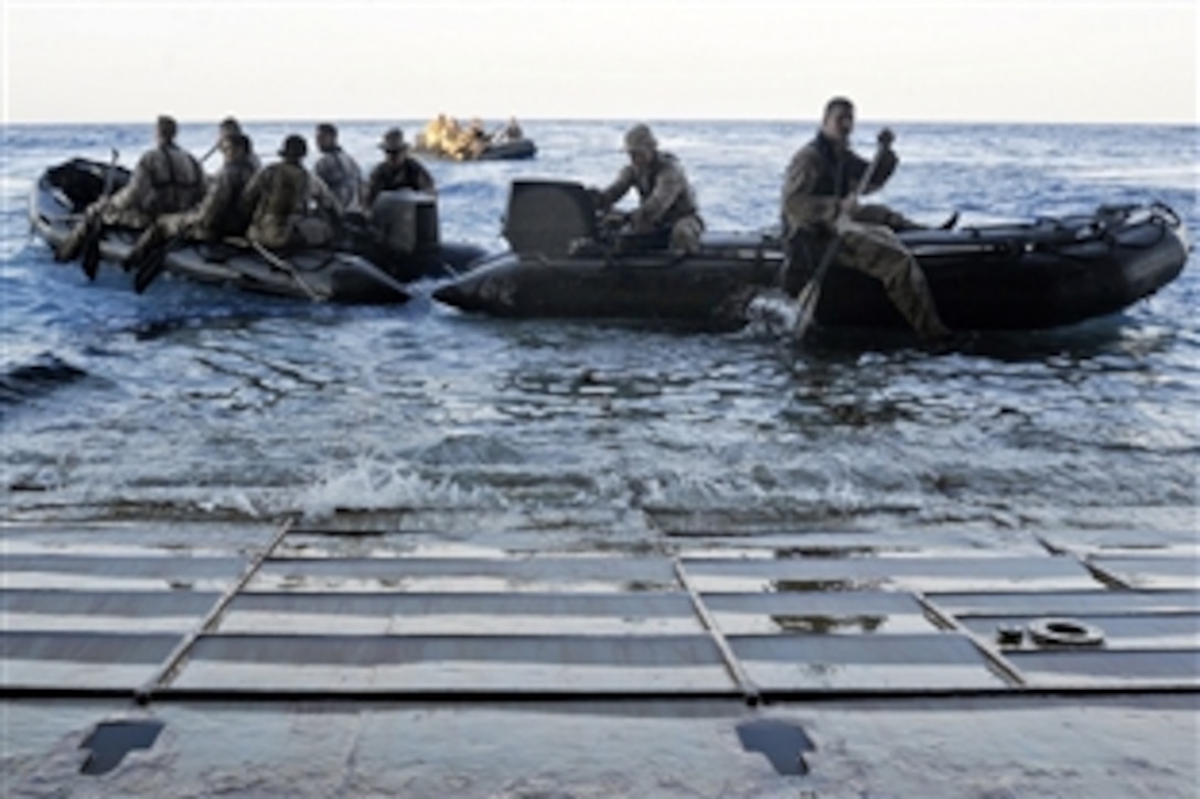 U.S. Marines launch combat rubber raiding craft from the stern gate of the forward-deployed amphibious assault ship USS Essex during a training mission, March 3, 2010. The Marines are assigned to the 31st Marine Expeditionary Unit.