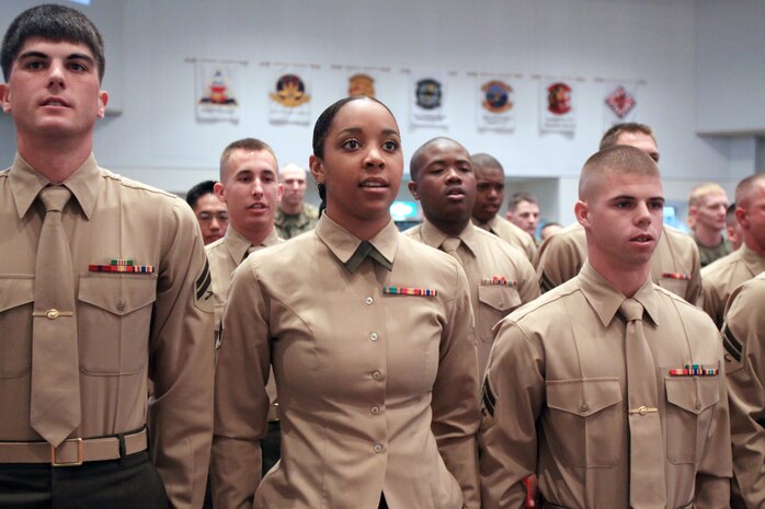Marines sing the Marines' Hymm at the Corporals Course graduation of Class 2-10 at the Marine Memorial Chapel here March 9. The course was 21 days long and covered Marine Corps knowledge, drill, physical training, sword manual and uniform inspections.
