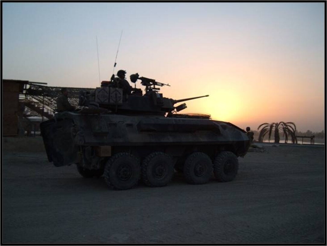 Marines from 2dLAR take a moment to witness the sunset from their LAV.