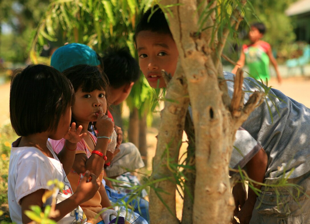 Marnay Primary School students eat snacks during recess, March 9. The residents of the local community observe daily as Armed Forces of the Philippines (AFP) and Combat Logistics Battalion-31, 31st Marine Expeditionary Unit, servicemembers work together in rebuilding a two-room classroom and a water tower at Marnay Primary School during exercise Balikatan 2010 (BK ’10).