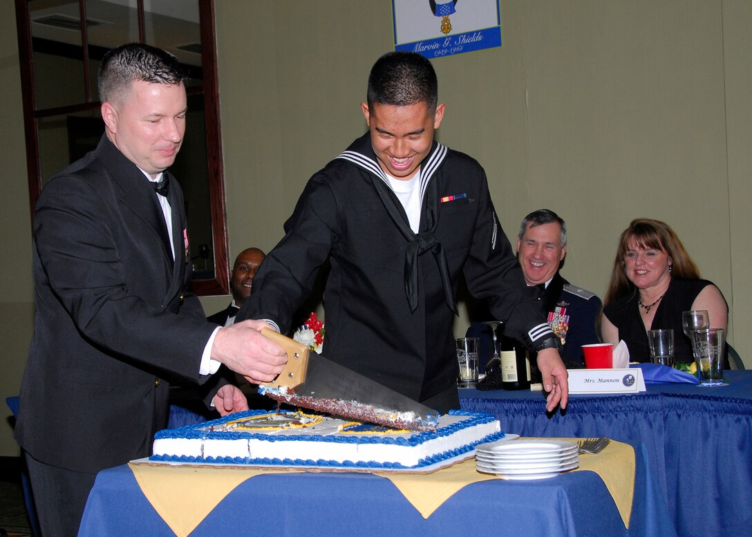 Chief Petty Officer Eric Kamradt (left), the oldest Seabee 366th Training Squadron, cuts the Seabee Anniversary cake with Seaman Ridge Roy (right), the youngest Seabee from the 366th TRS during the 68th Annual Seabee Ball in Wichita Falls, Texas, March 5. (U.S. Air Force photo/Harry Tonemah)