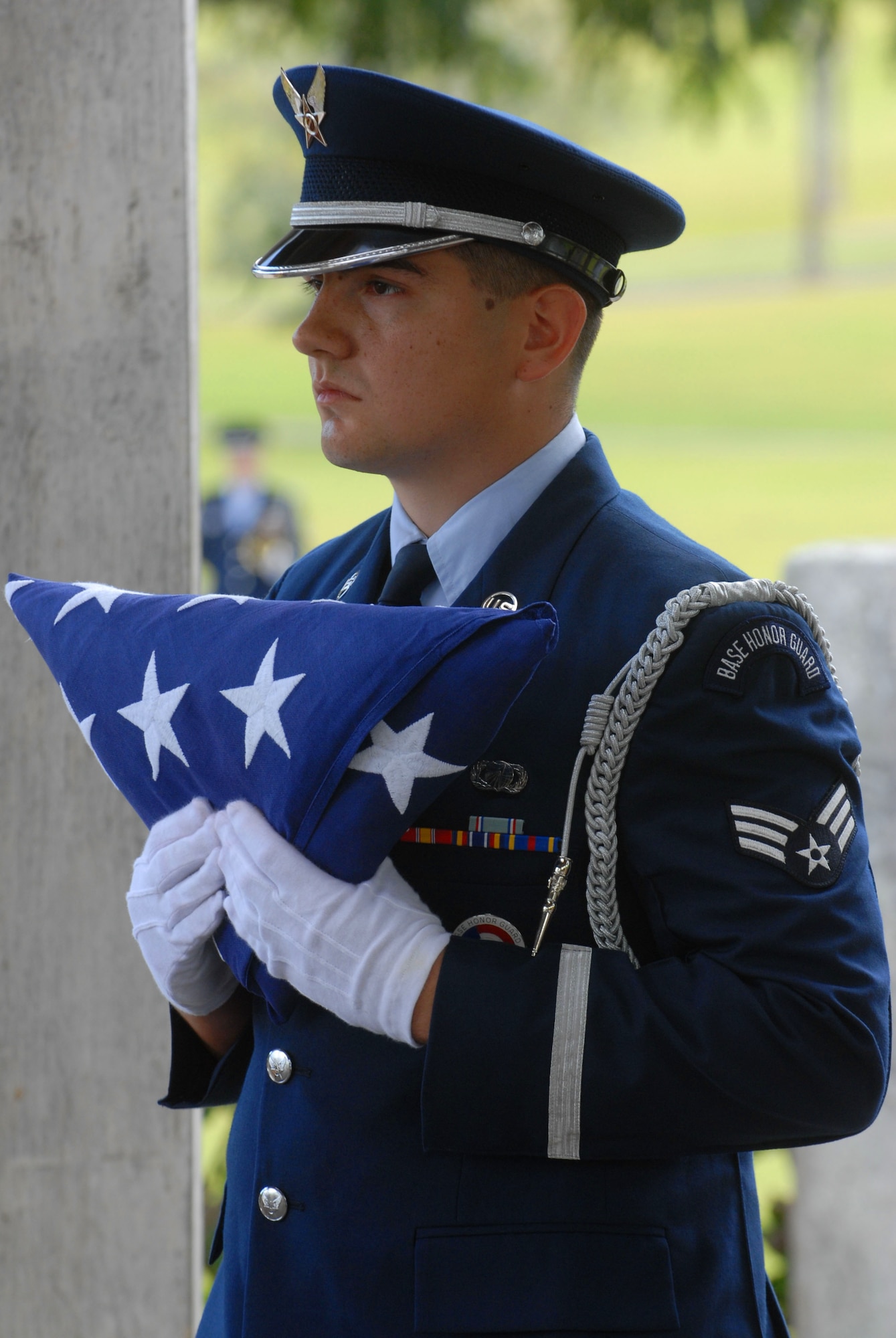 JOINT BASE PEARL HARBOR HICKAM, Hawaii - Senior Airman Marcos Morales, 15th Contracting Squadron, holds the flag during a deceased veteran's funeral at the Hawaii State Veterans Cemetery in Kaneohe, March 5. The Hickam Honor Guard has the resposibility of representing the U.S. Air Force throughout the Hawaiian Islands as friends and family gather to pay their final respects to to family members and loved ones who served honorably for their country. (U.S. Air Force photo/Senior Airman Gustavo Gonzalez)