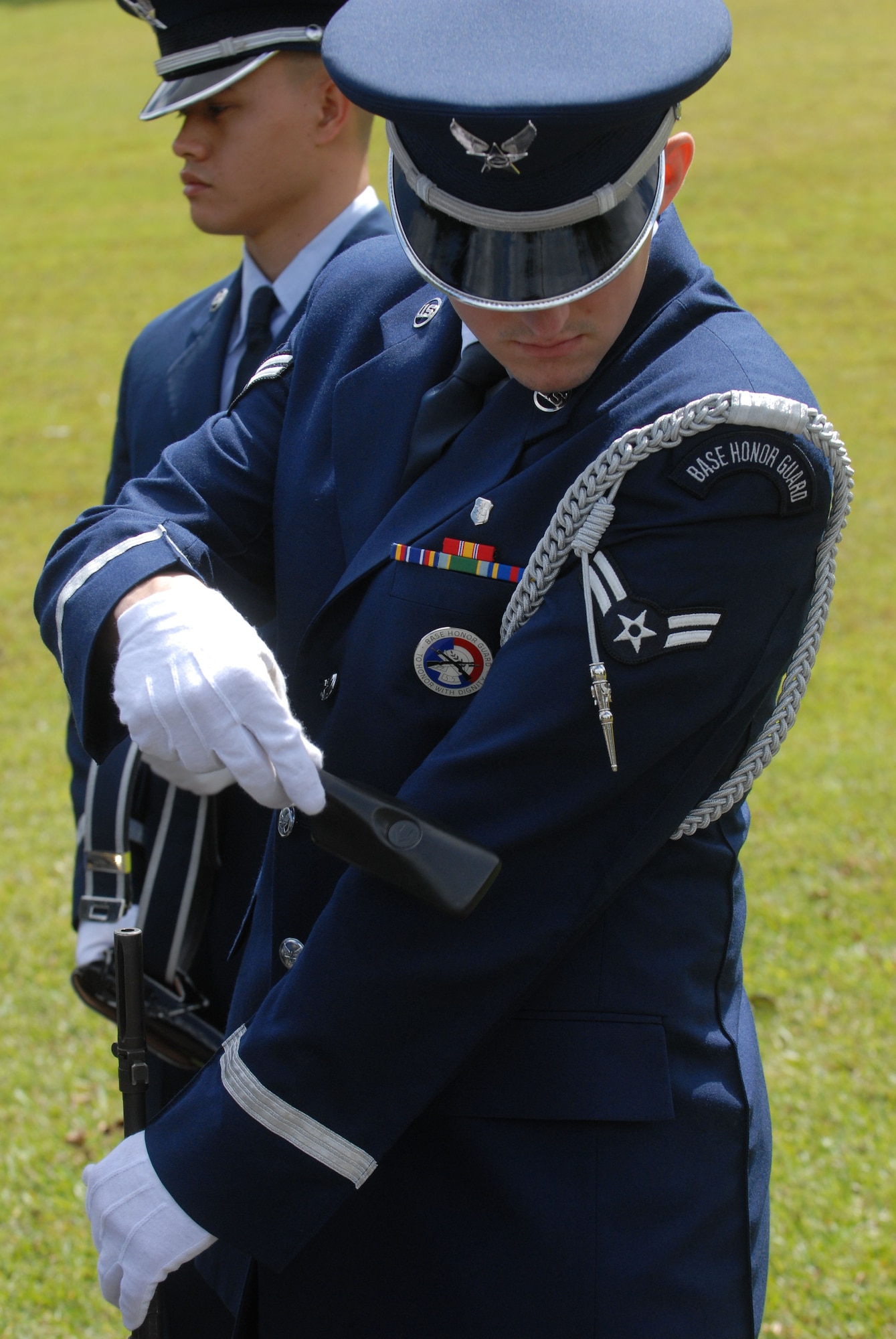JOINT BASE PEARL HARBOR HICKAM, Hawaii - Airman 1st Class Alex Devus, 15th Aeromedical Dental Squadron, cleans lint from his service coat before a funeral at the Hawaii State Veterans Cemetery in Kaneohe, March 5. The Hickam Honor Guard has the resposibility of representing the U.S. Air Force throughout the Hawaiian Islands as friends and family gather to pay their final respects to to family members and loved ones who served honorably for their country. (U.S. Air Force photo/Senior Airman Gustavo Gonzalez)